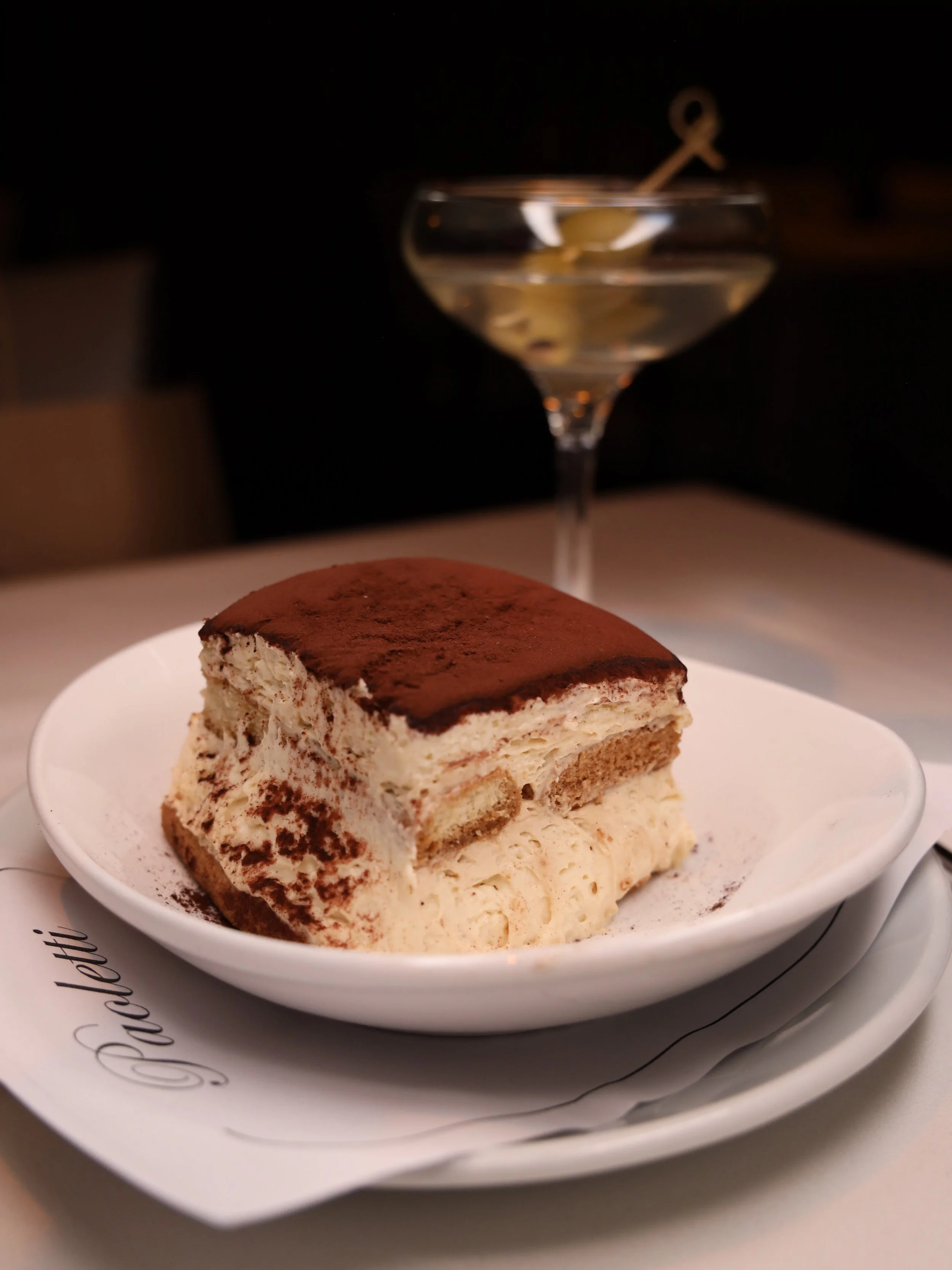 A slice of tiramisu at Ristorante Paoletti, dusted with cocoa powder.