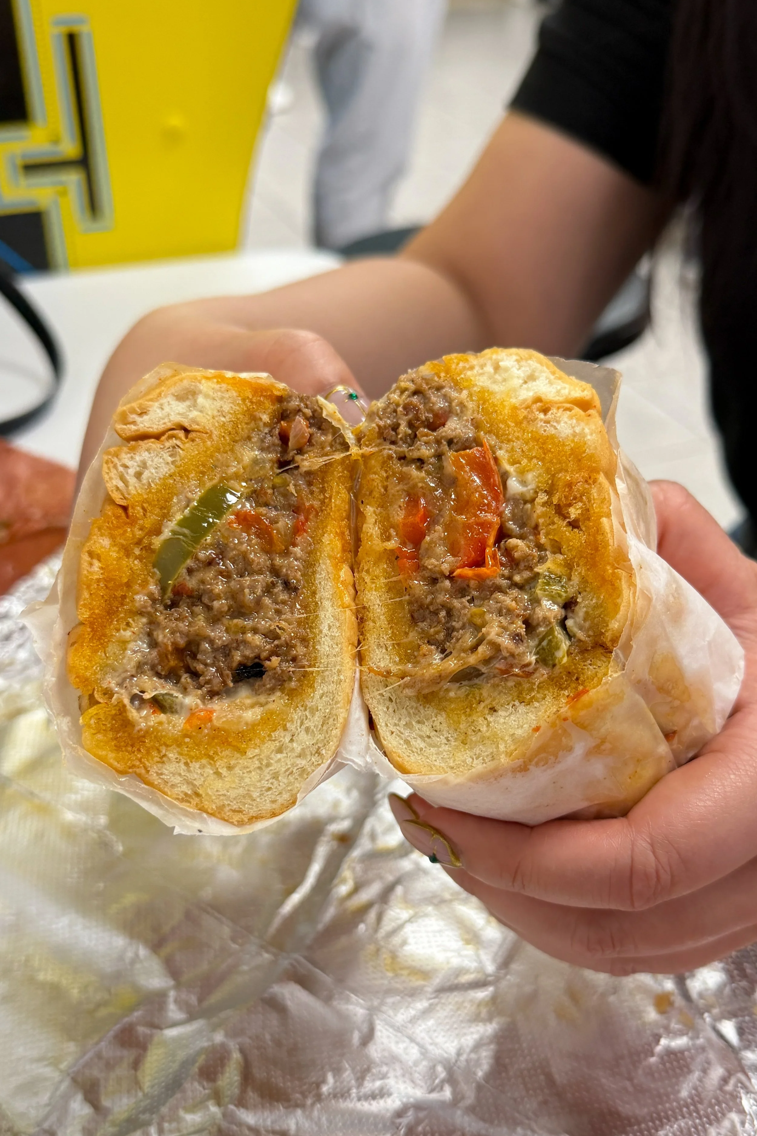 The Philly Chopped Cheese at Mochi's Deli in Charlotte, ground beef and melted cheese folded with grilled onions and peppers.