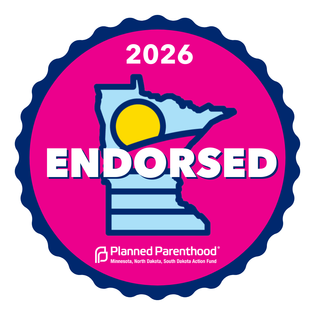 A political endorsement badge featuring an outline of Minnesota with a yellow sun graphic inside, the word 'ENDORSED' in large white text, and the year 2026 at the top. The badge is pink with a dark blue border, and at the bottom, there is the Planned Parenthood logo along with text indicating it is for Minnesota, North Dakota, and South Dakota Action Fund.