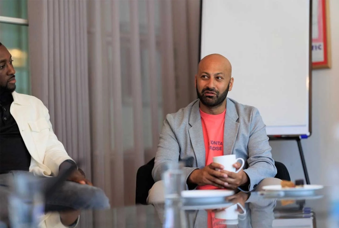 Gary sharing ideas and discussing around a table with other people