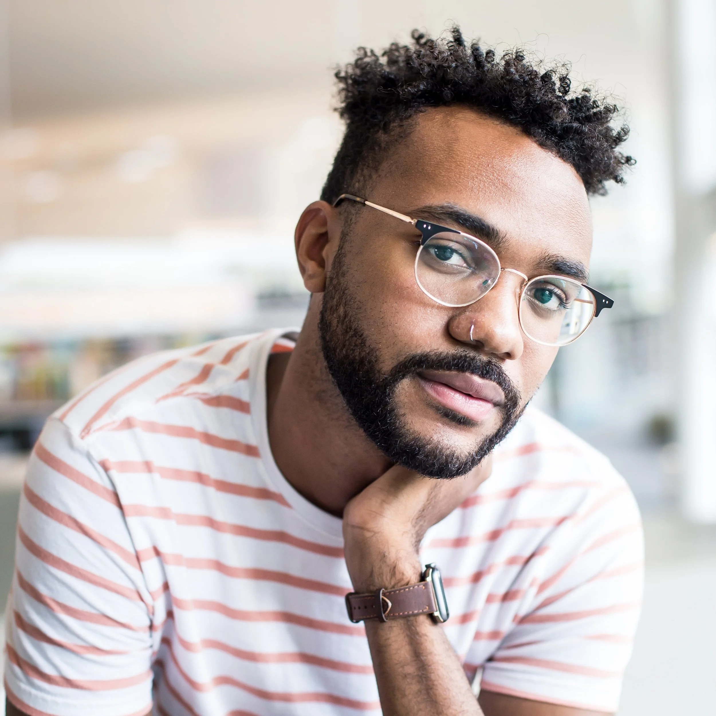 Young black man with glasses and nose piercing