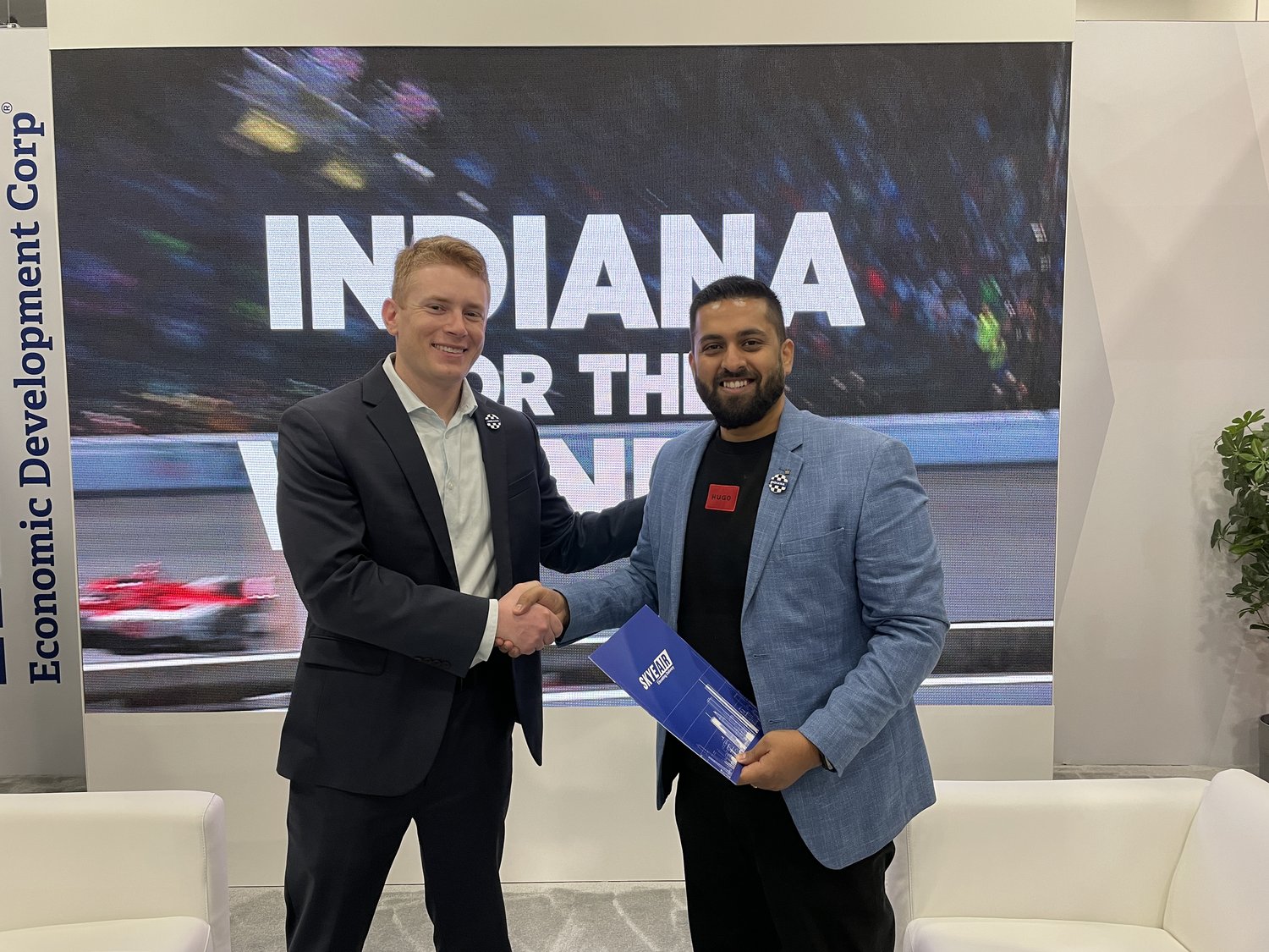 Aaron Pierce and Ankit Kumar pose for a photograph at the Indiana Economic Development Corporation's booth at CES in Las Vegas, NV.