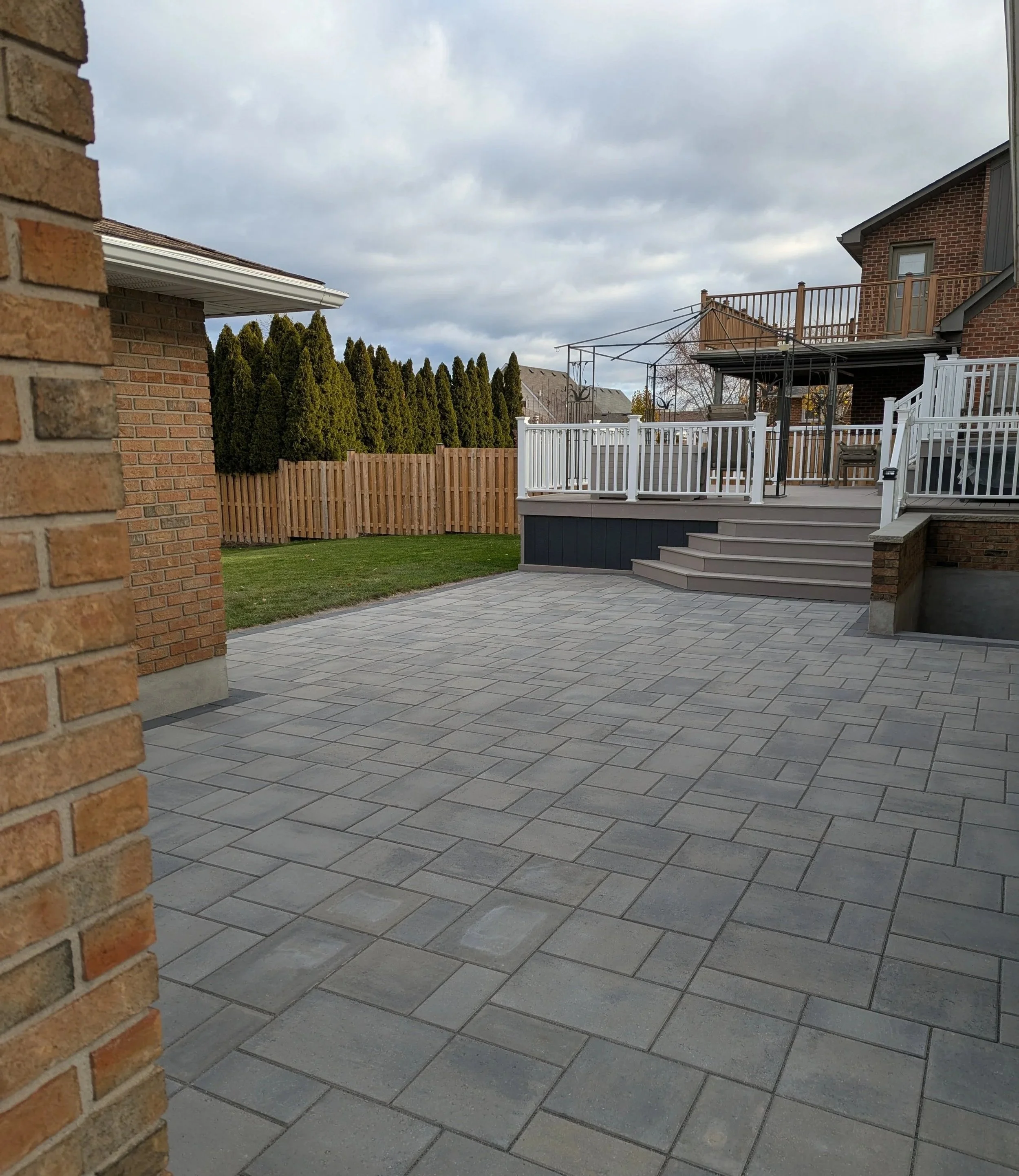 Wide view of a professional  paver patio installation featuring Techo-Bloc Blu 60 interlock.