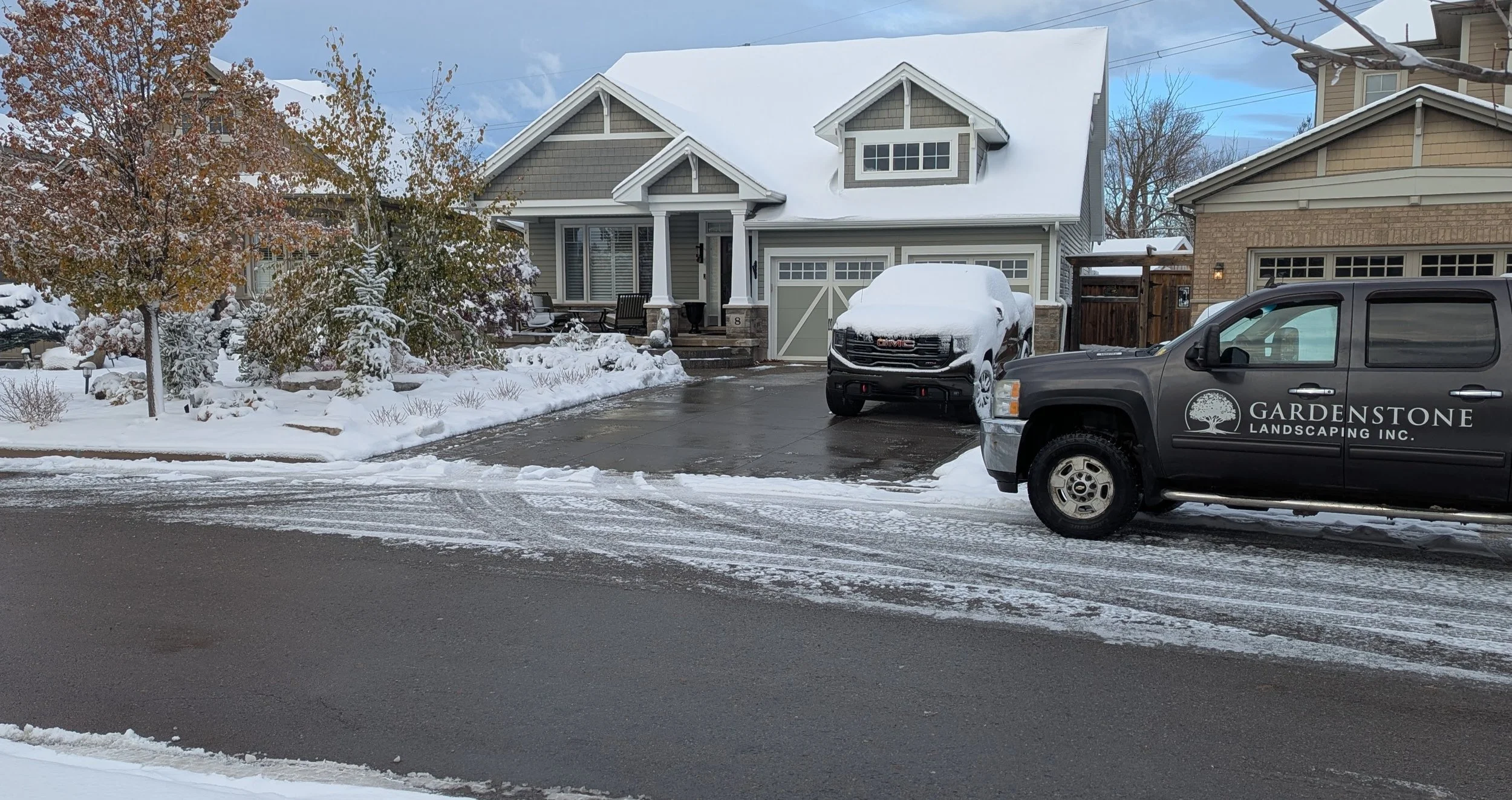 Gardenstone Landscaping professional snow removal services clearing a residential driveway in Smithville during winter.