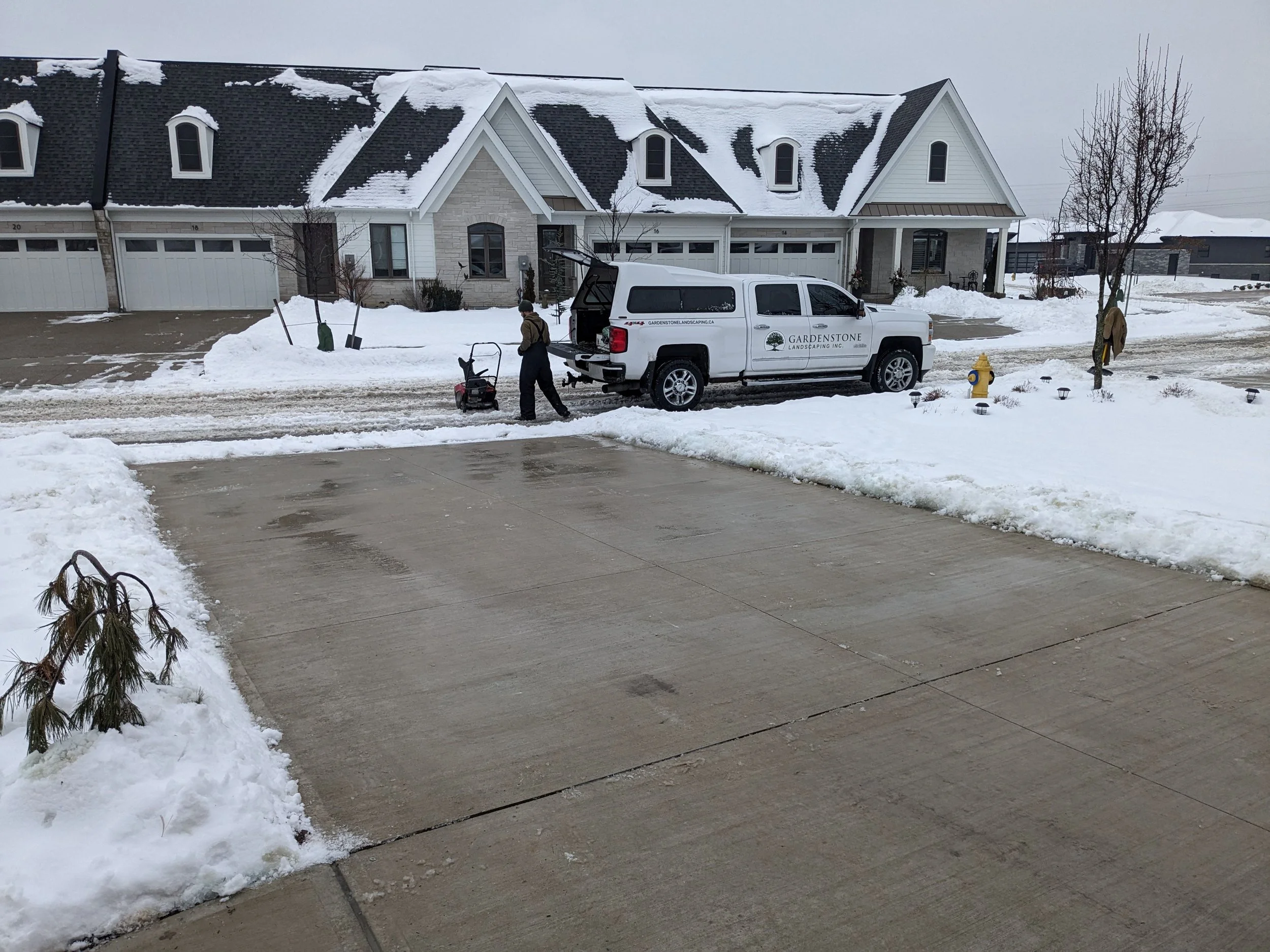 Professional snow removal service in St. Catharines showing a wide residential driveway completely cleared of snow and salted down to the pavement after a winter storm.