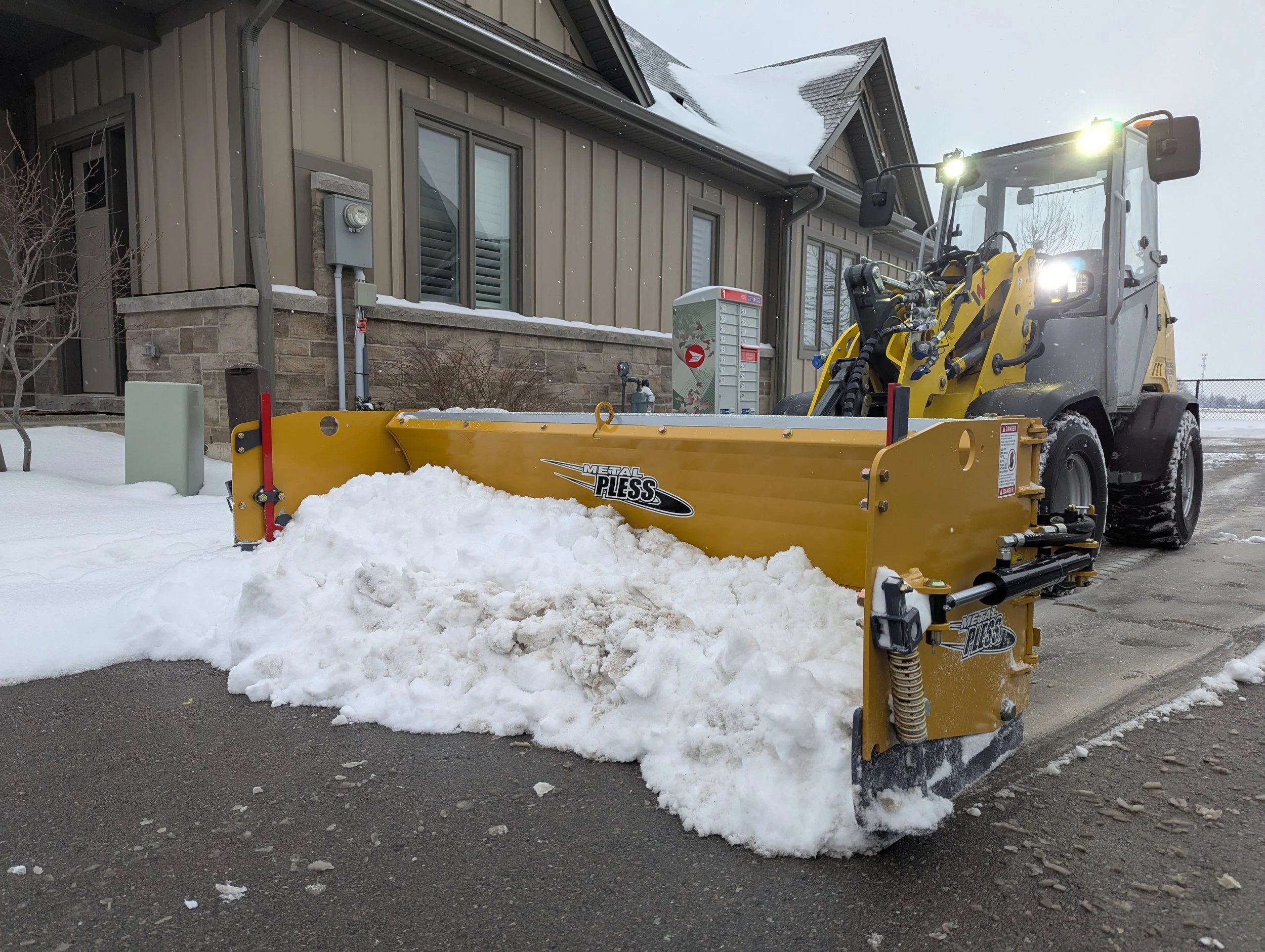 Snowplow clearing snow in Smithiville 