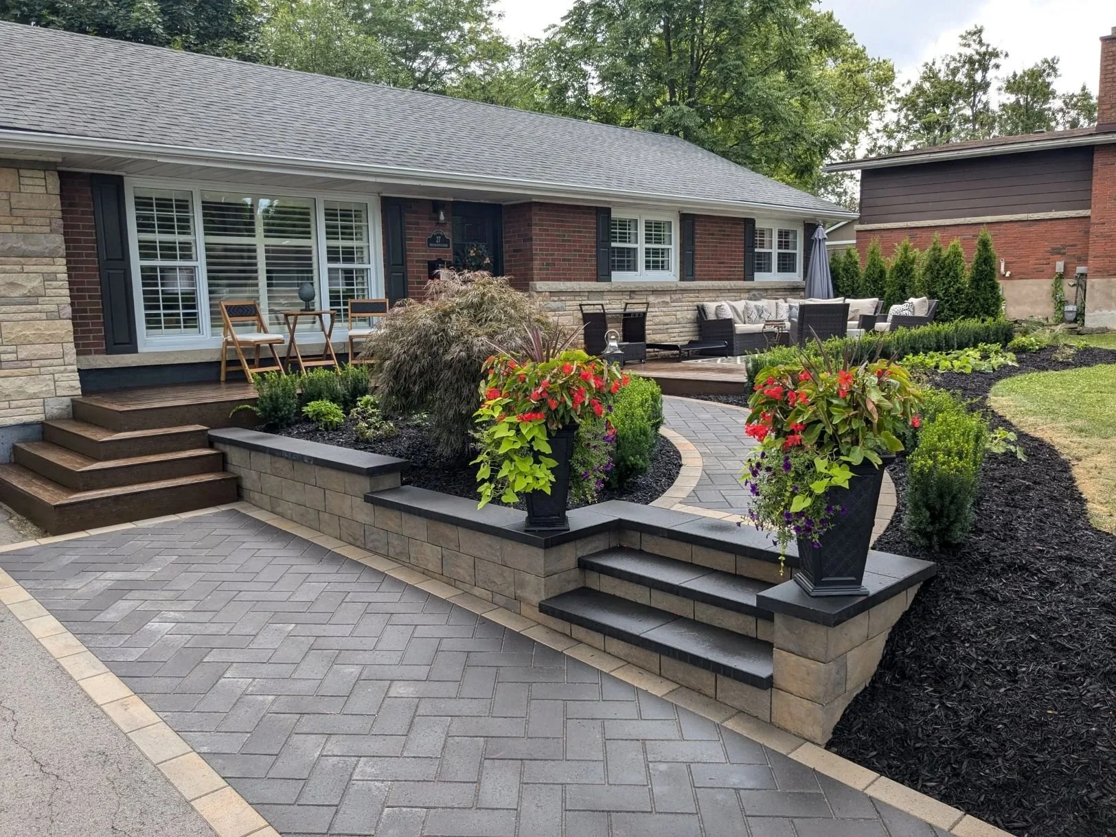 Modern walkway featuring Techo-Bloc's Brandon wall and Blu 80 pavers in a herringbone pattern in St. Catharines