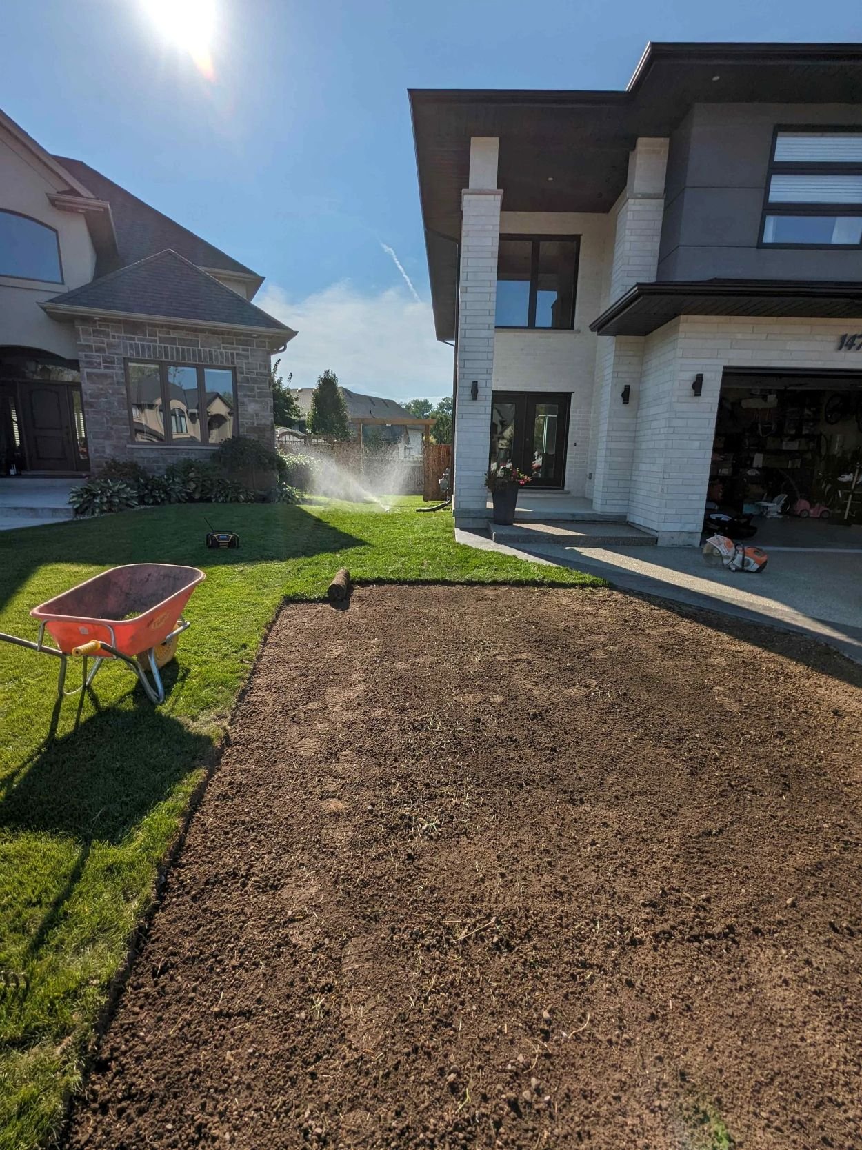 Professional sod installation and initial watering for a new build property in Welland by Gardenstone Landscaping.