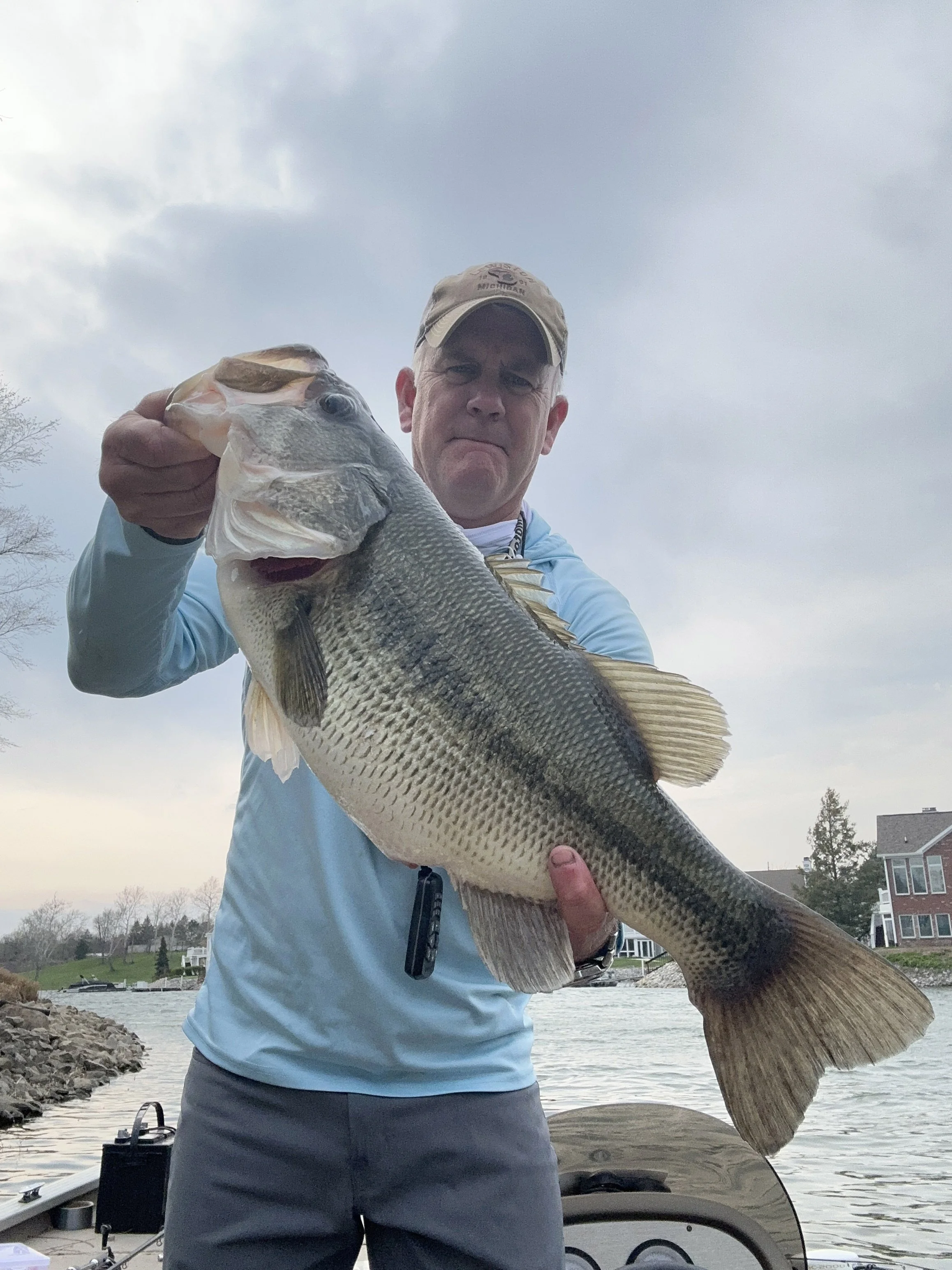 Trophy 8-pound largemouth bass caught in Indianapolis in 2025, showcased by angler on a residential lake.