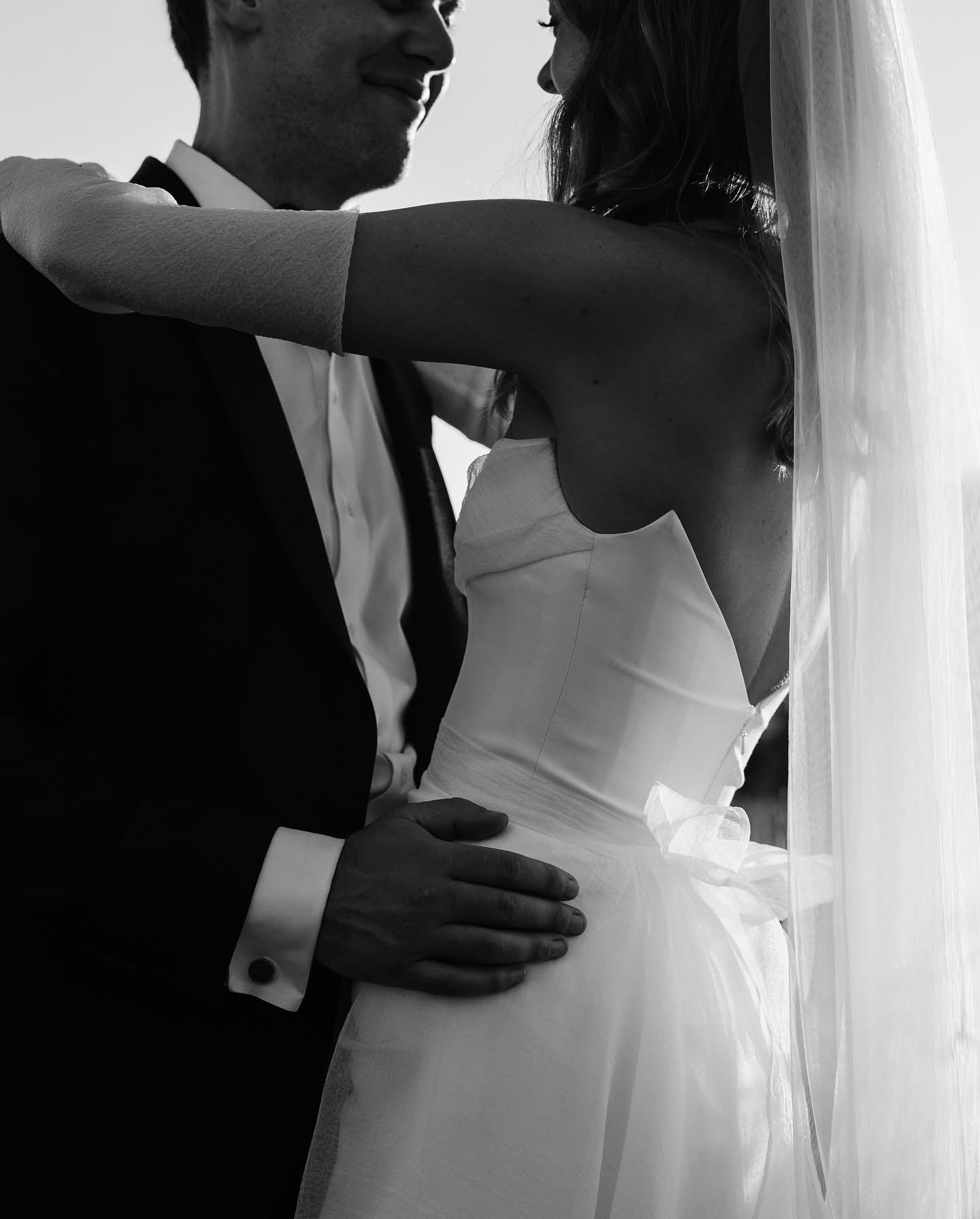 Black and white image of a bride and groom sharing an intimate moment captured by Tonya Hjort Photography