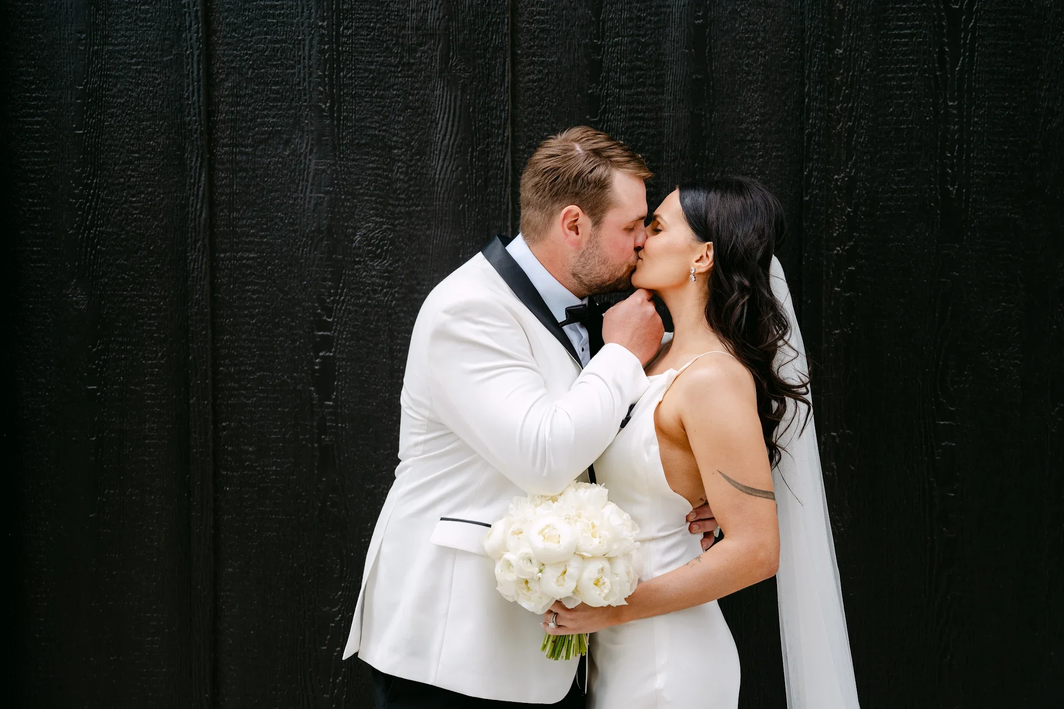Tonya Hjort Photography captures Caitlyn and her husband sharing a kiss