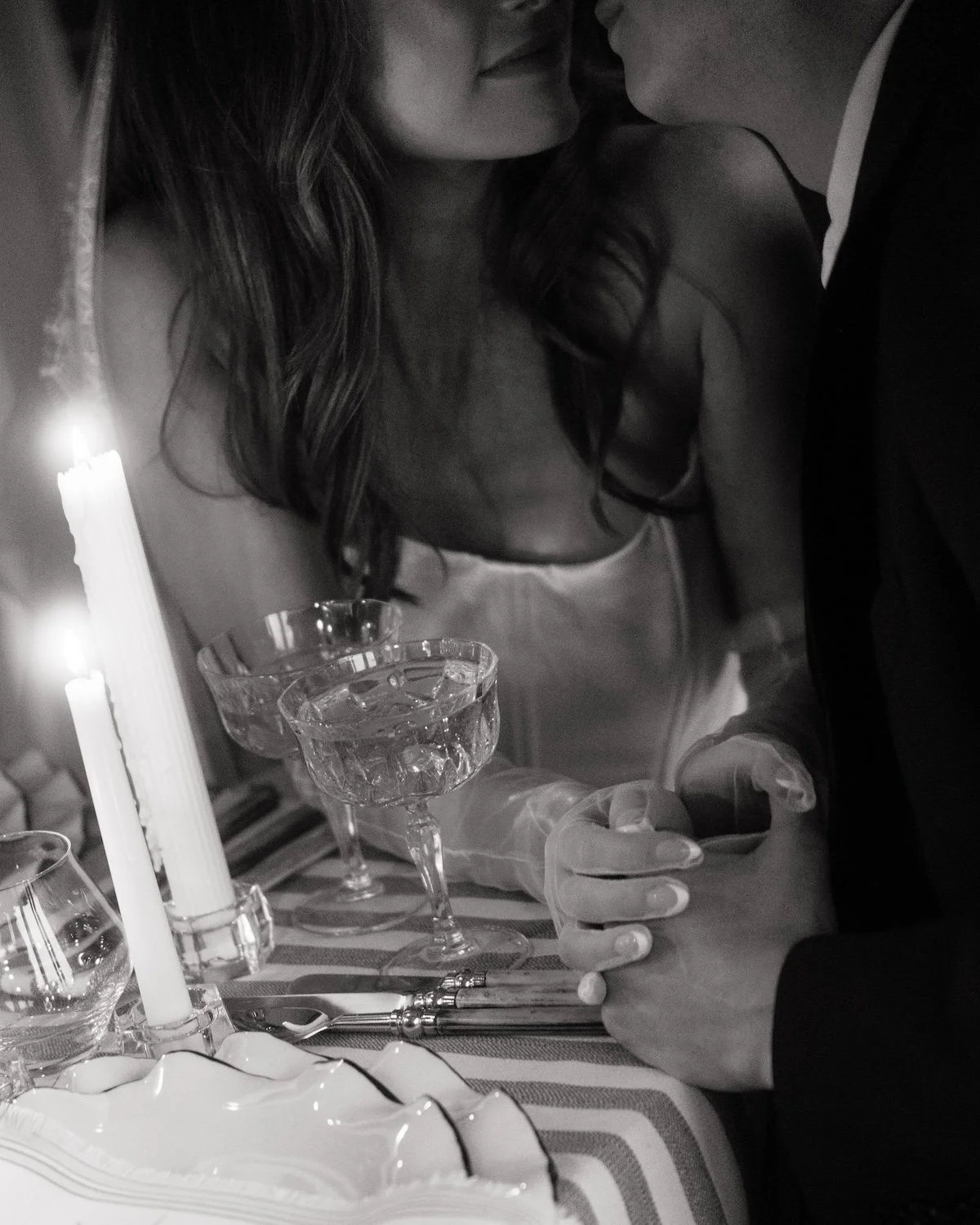 Intimate black and white image of a bride and groom sitting closely and holding hands photographed by Tonya Hjort Photography in Minneapolis, MN