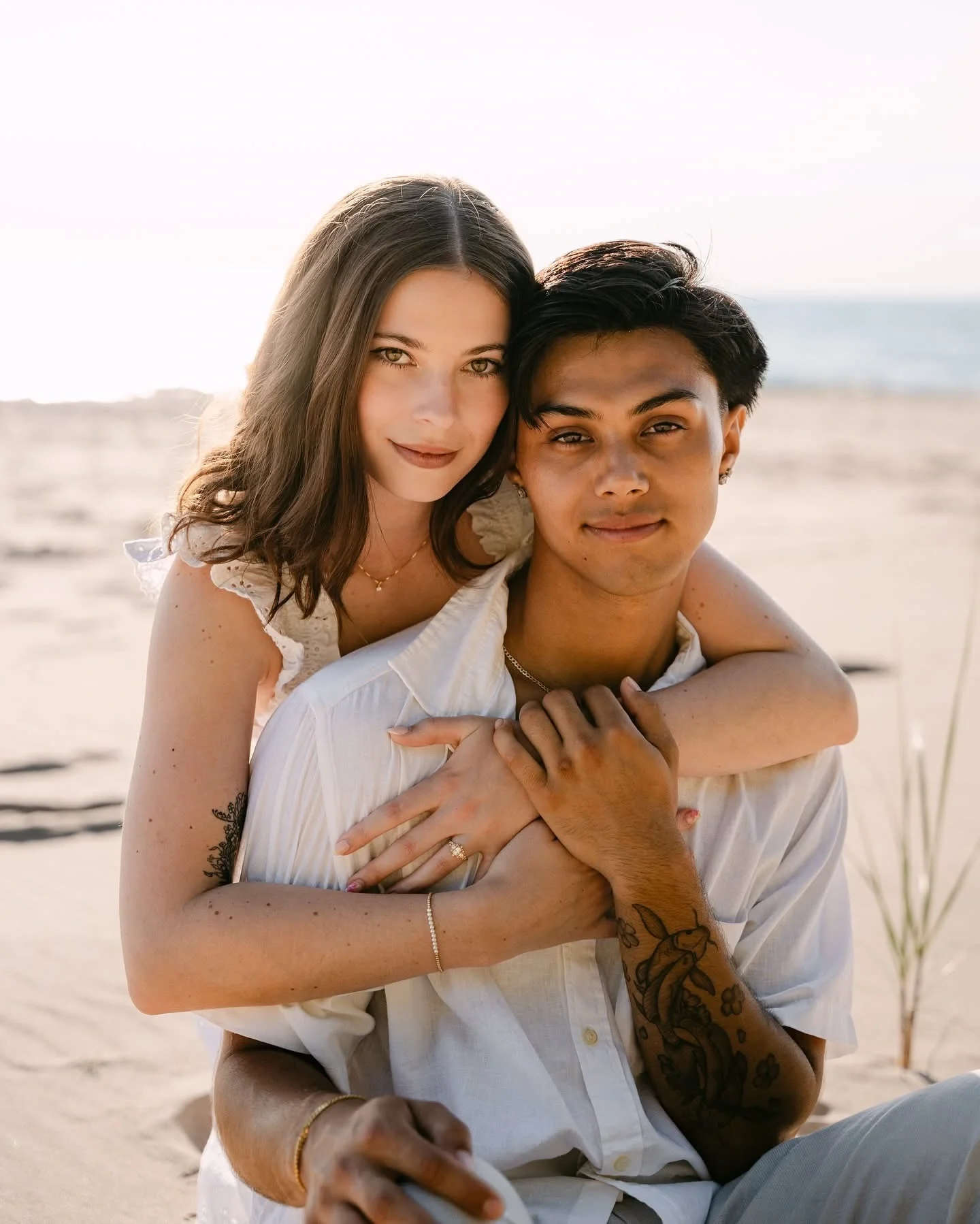 Couple embaces on the shoreline of Lake Michigan photographed by Tonya Hjort Photography