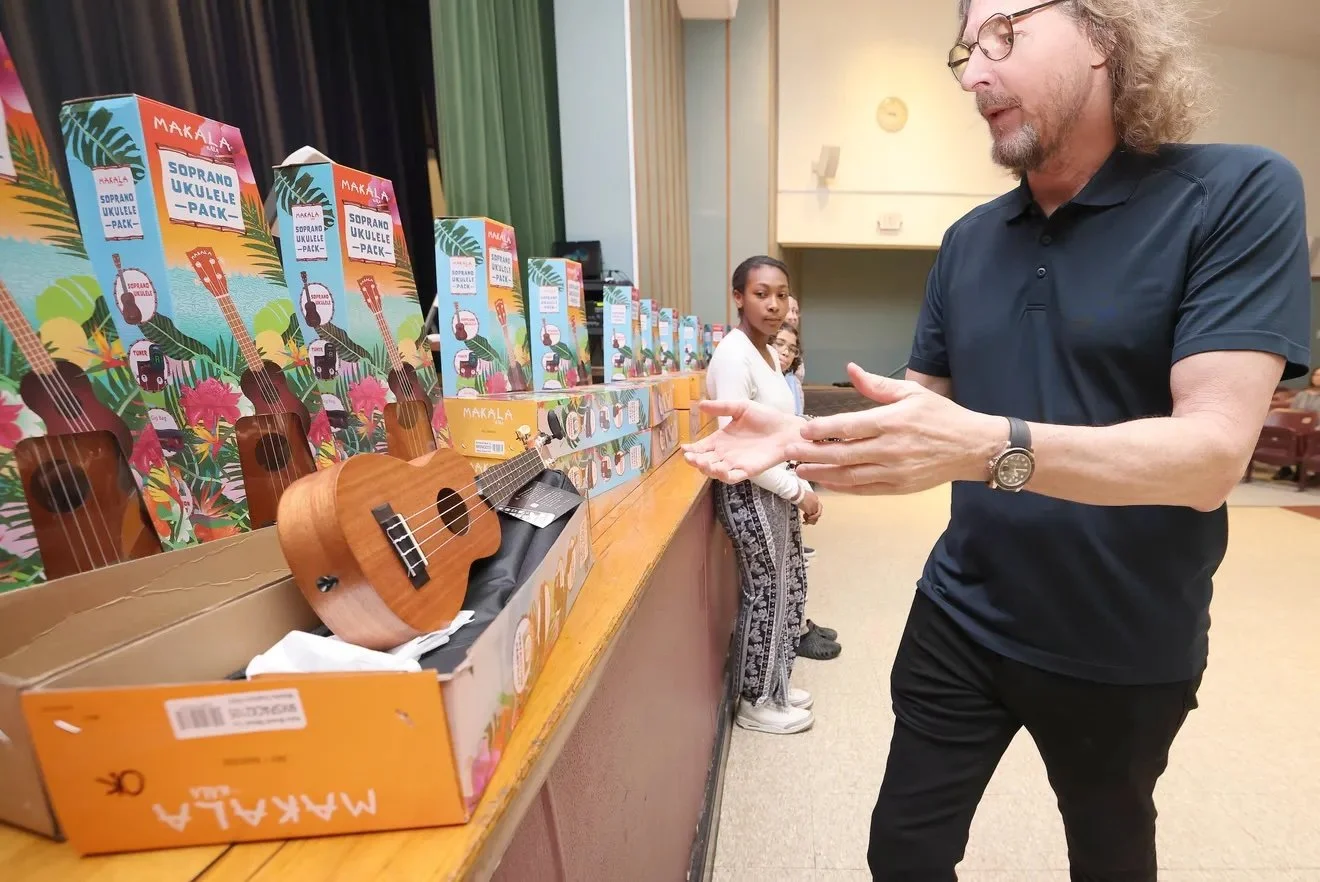  Ernie Boch Jr. grabs a ukulele to give to band student Kiarah Jackson, 12, at East Middle School in Brockton on Thursday, May 8, 2025. 