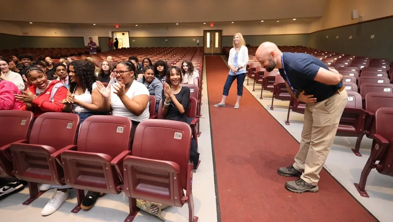  Teacher Tom Gallagher, who likes to play his guitar in the hallways, takes a bow as Ernie Boch Jr. donates 50 ukuleles to East Middle School in Brockton on Thursday, May 8, 2025. 