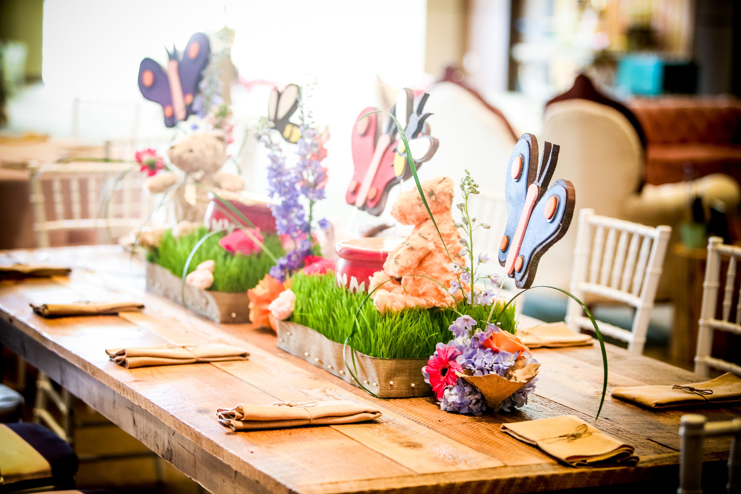 butterfly garden event centerpiece on wood table