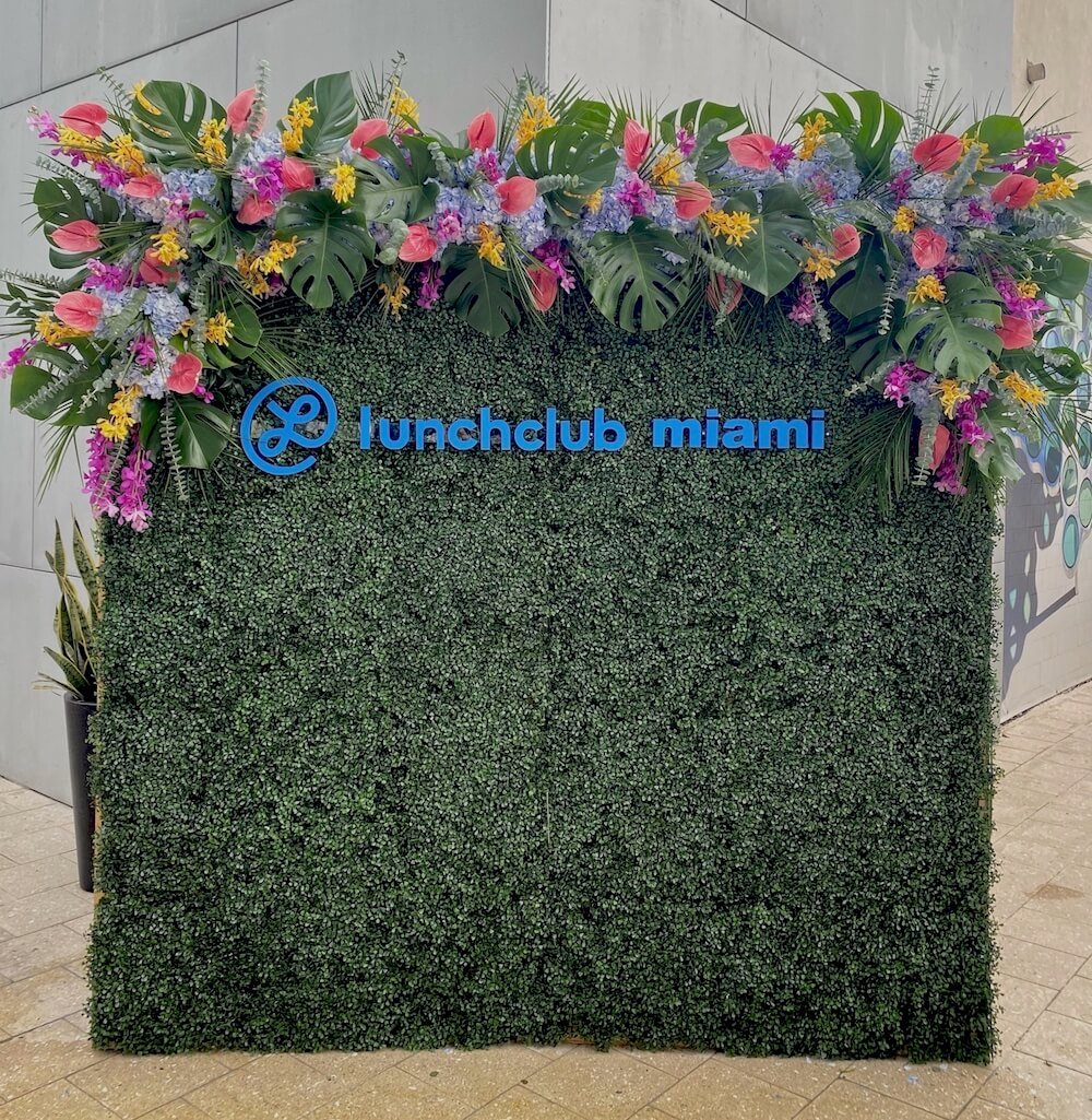 Event backdrop for photobooth that says "Lunchclub Miami"