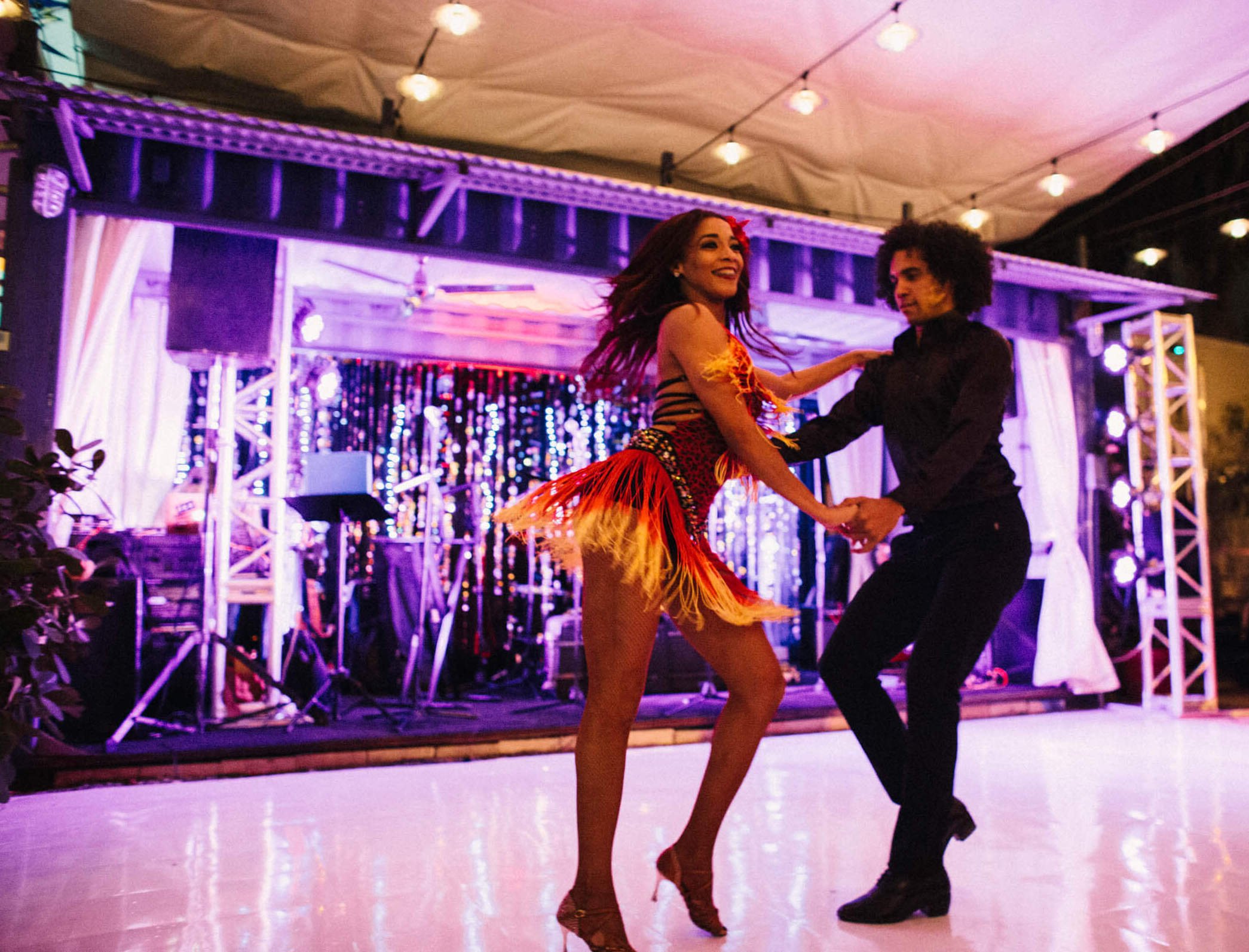 Dancers performing at an event - a man and woman caught mid step