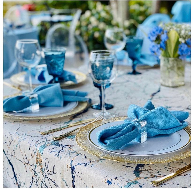 Beautiful Blue Tablescape with marble tablecloth, blue napkins, and blue floral tying it all together.