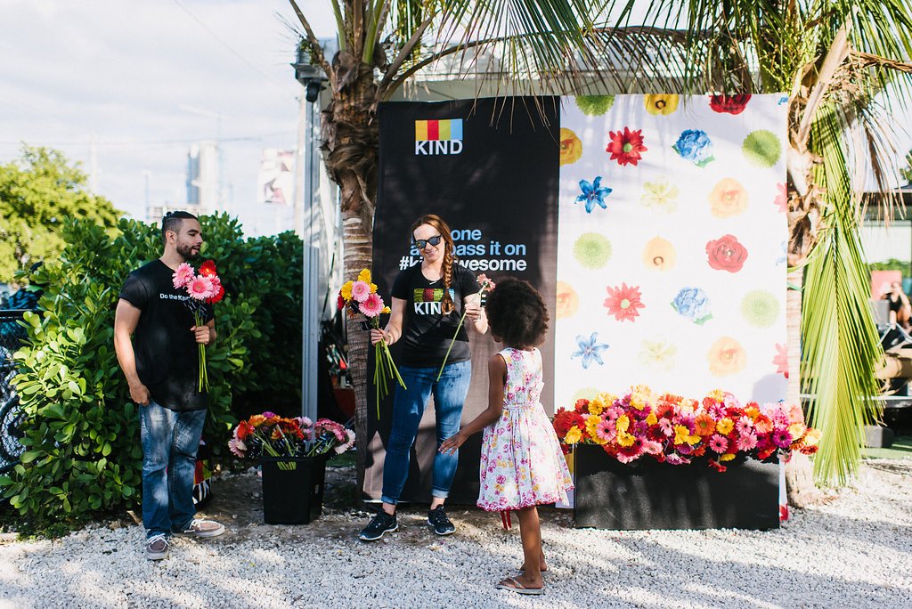 kind brand activation giving out flowers to passerby