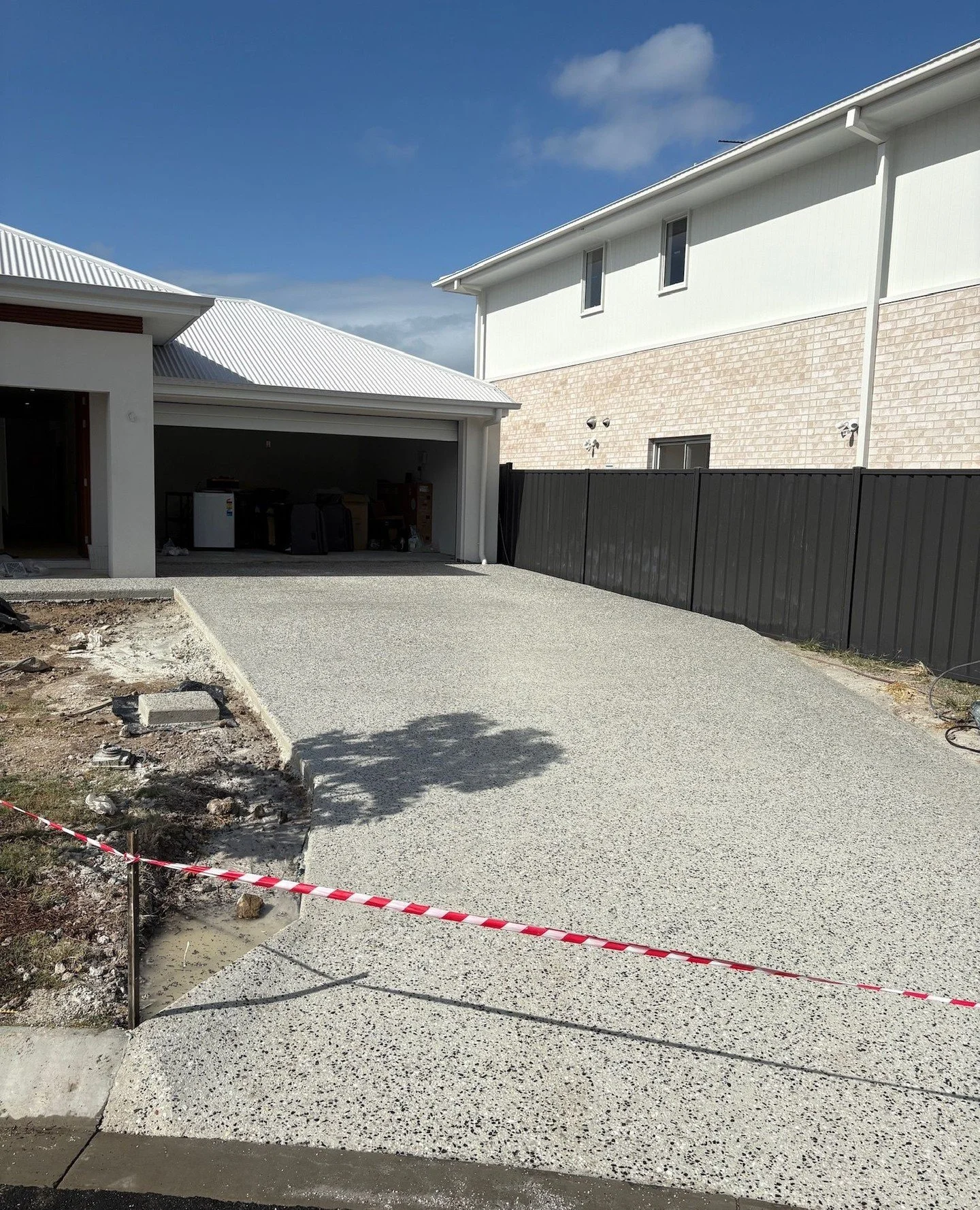 Clean driveway pour with exposed aggregate. Quality driveway work is what we do best. Swipe to see the process from start to finish.⁠