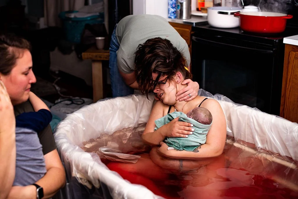 Mother Holds Newborn Baby To Chest in Birthing Pool At Home in Springfield, Oregon