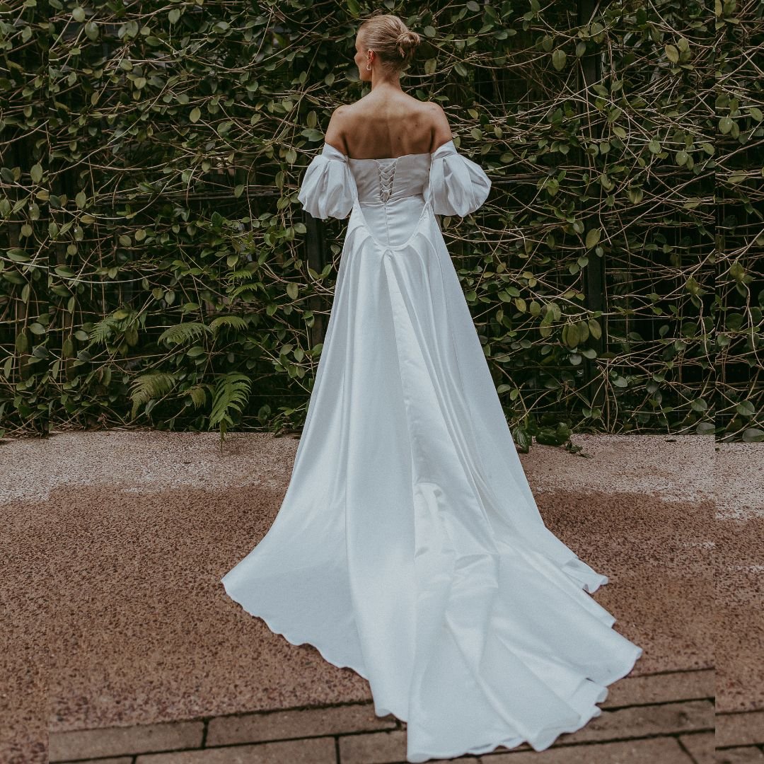 Minimalist custom bridal gown with lace up back and removeable cape