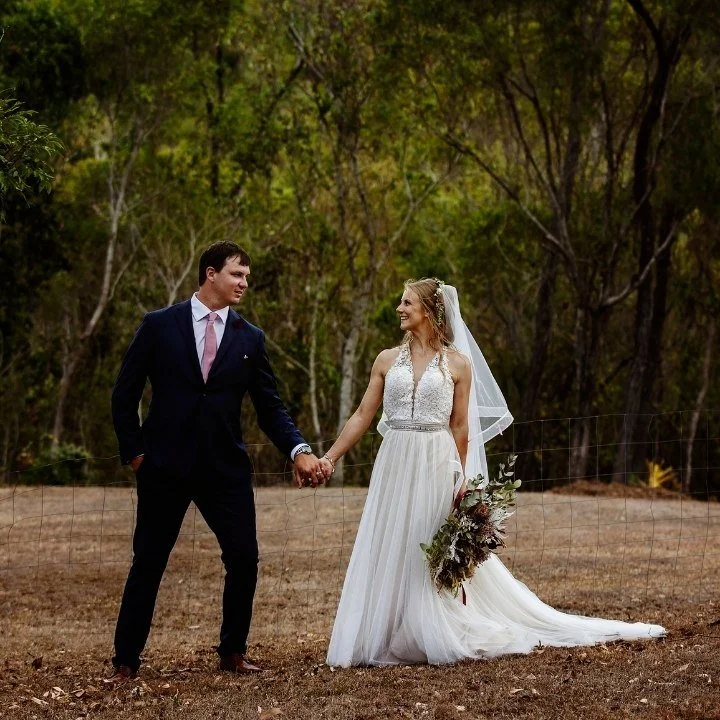 Real bride wearing a custom wedding gown featuring delicate lace detailing and a flowing skirt, blending romance and simplicity.