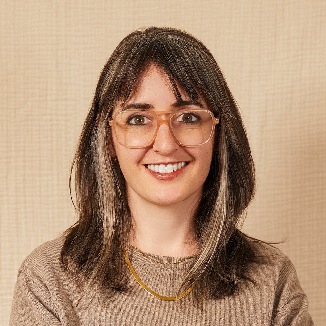 Acree Graham Macam standing against a beige wall.