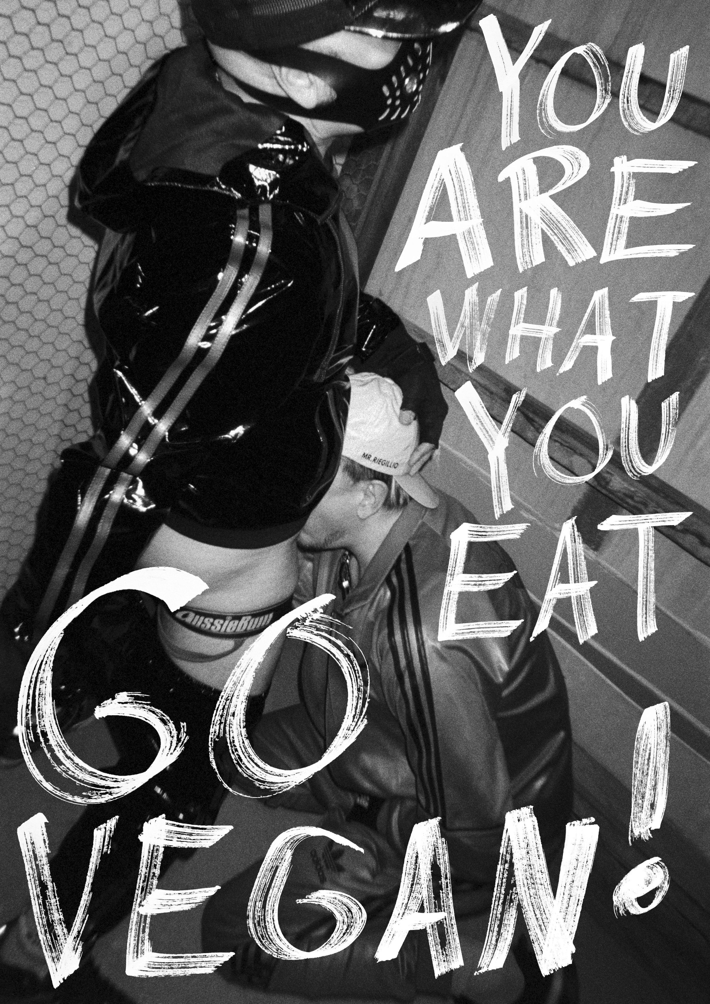 A black-and-white photo of a person kissing a dog, with handwritten-style text overlay that says 'You Are What You Eat' and 'Go Vegan!'