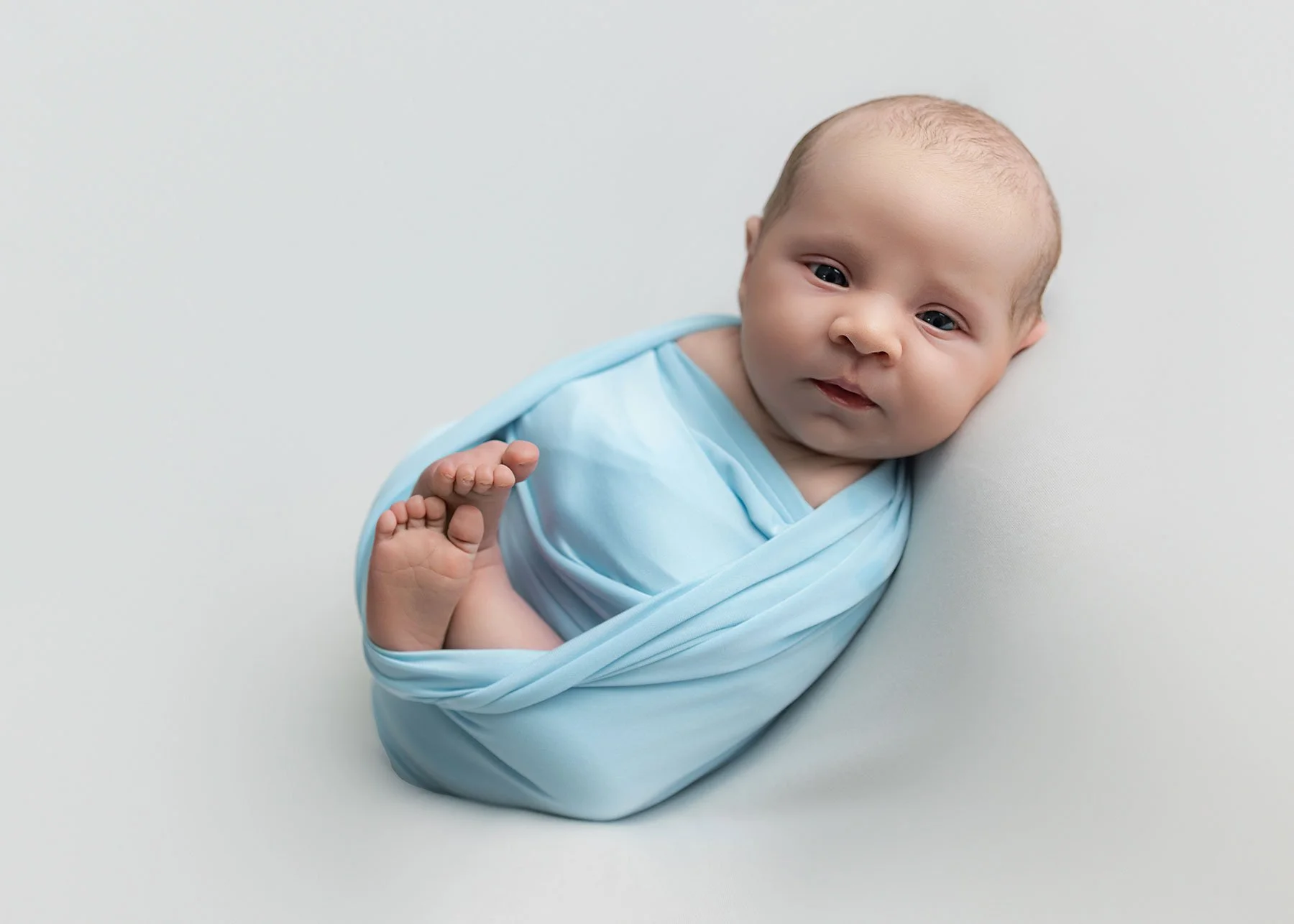 Baby on a photoshoot looking at camera