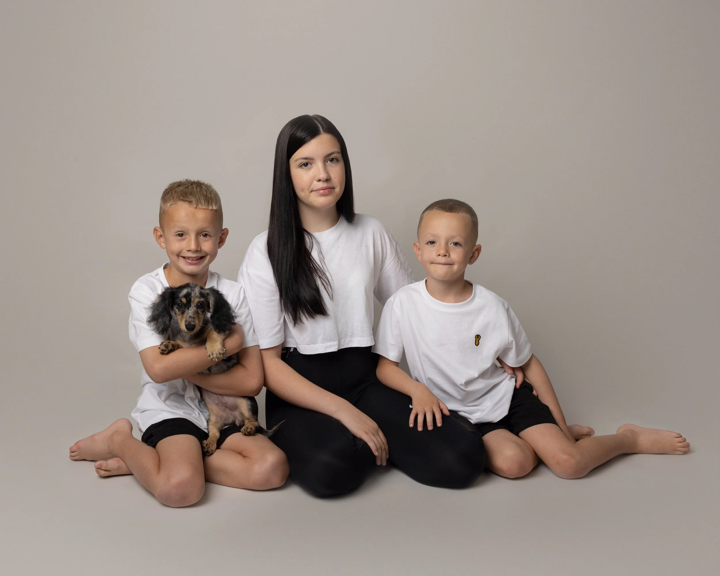Siblings with dog on a photoshoot