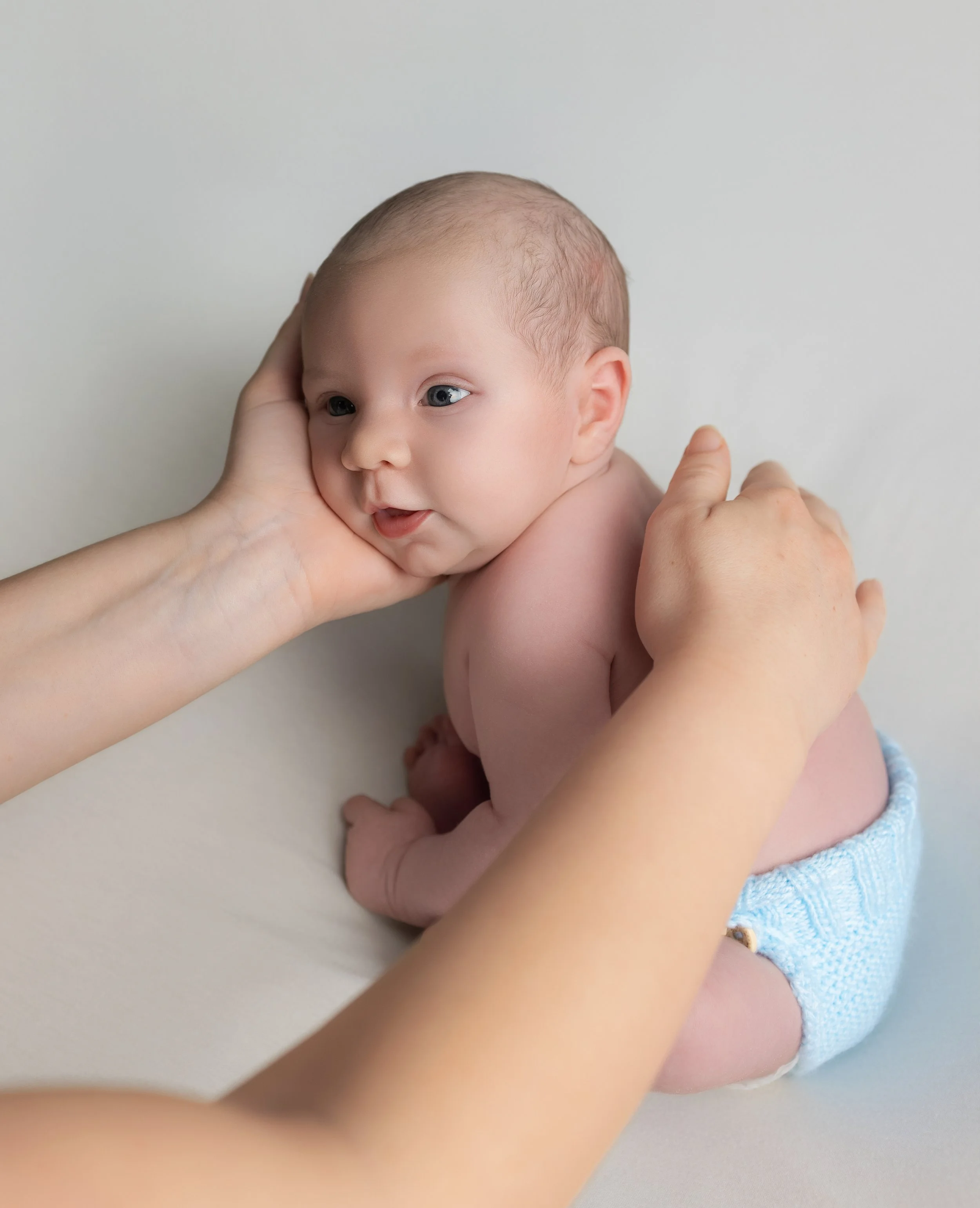 mum holding baby in her hands 