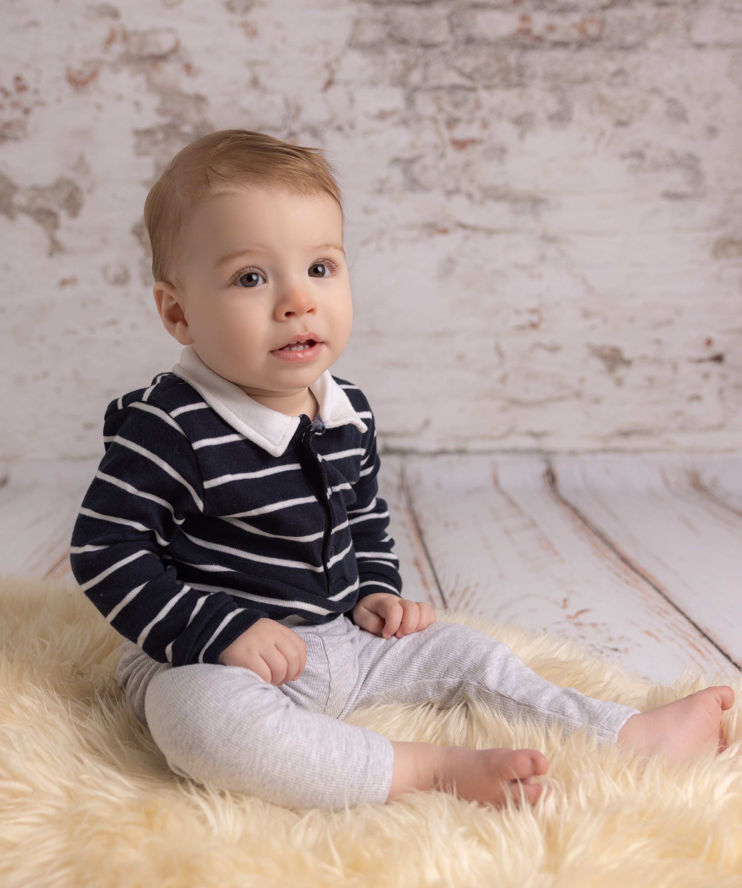 baby sat on a rug on a photoshoot