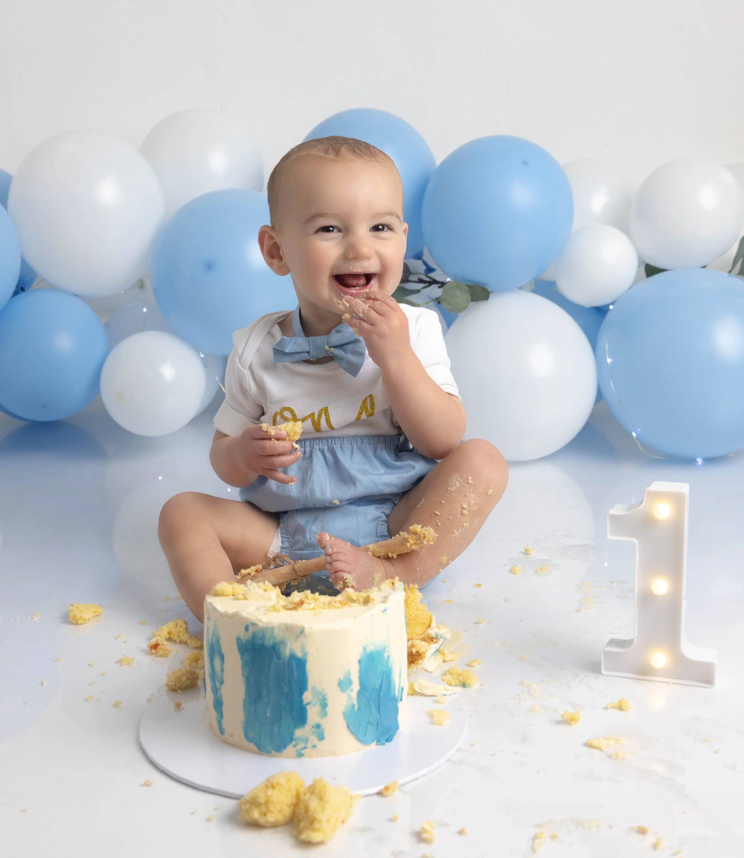 baby smiling whilst eating cake 