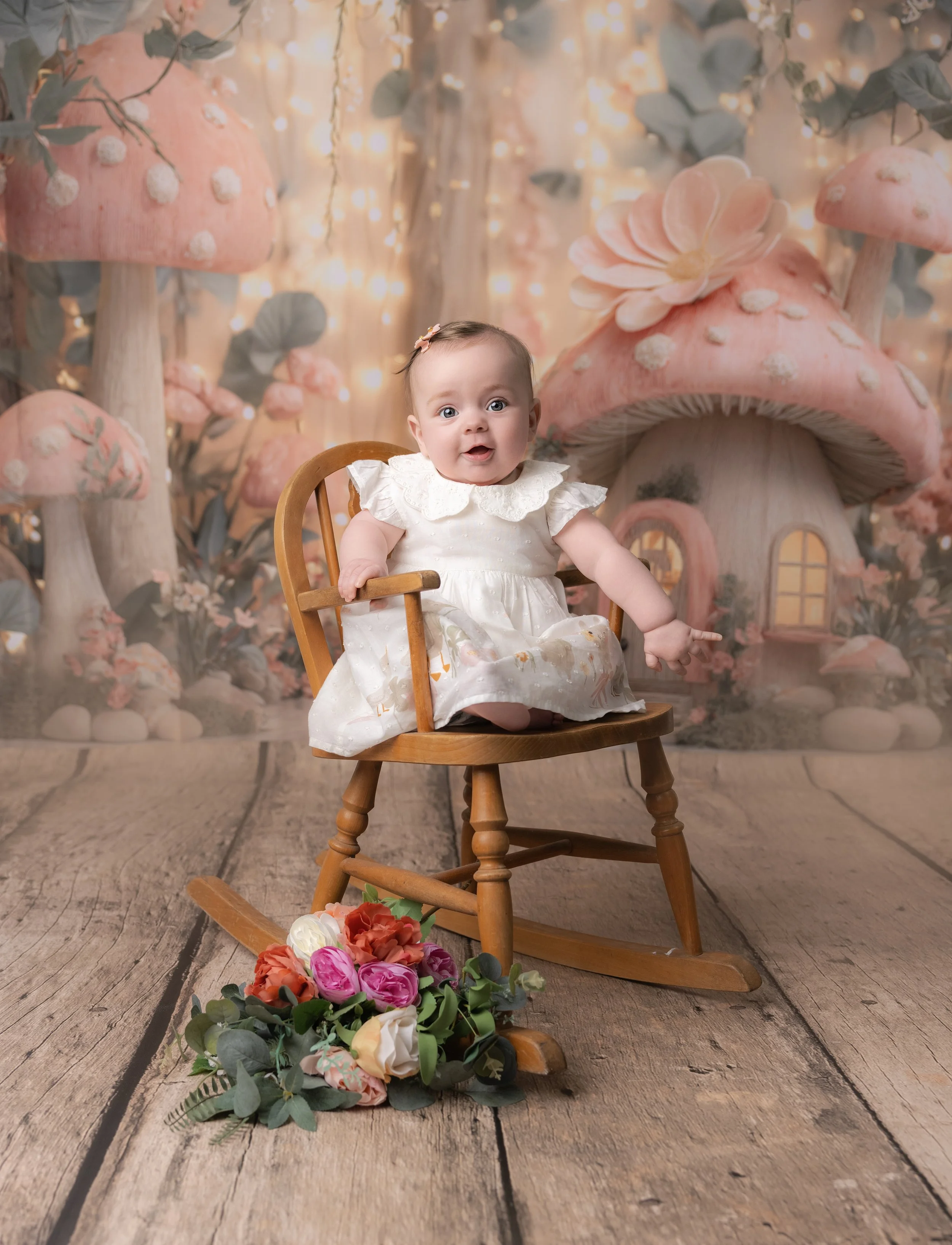 baby girl sat in a rocking chair