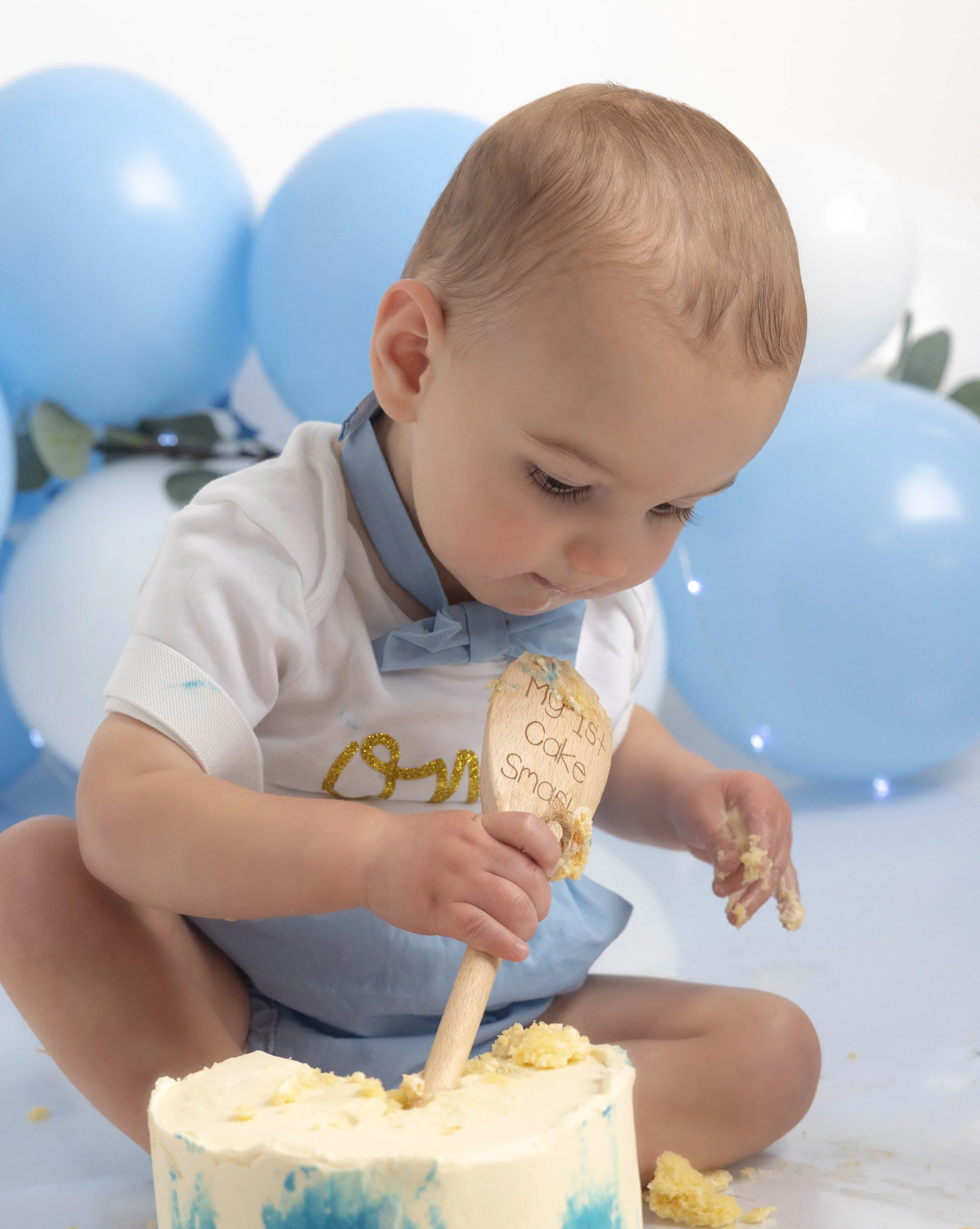 baby digging into cake 