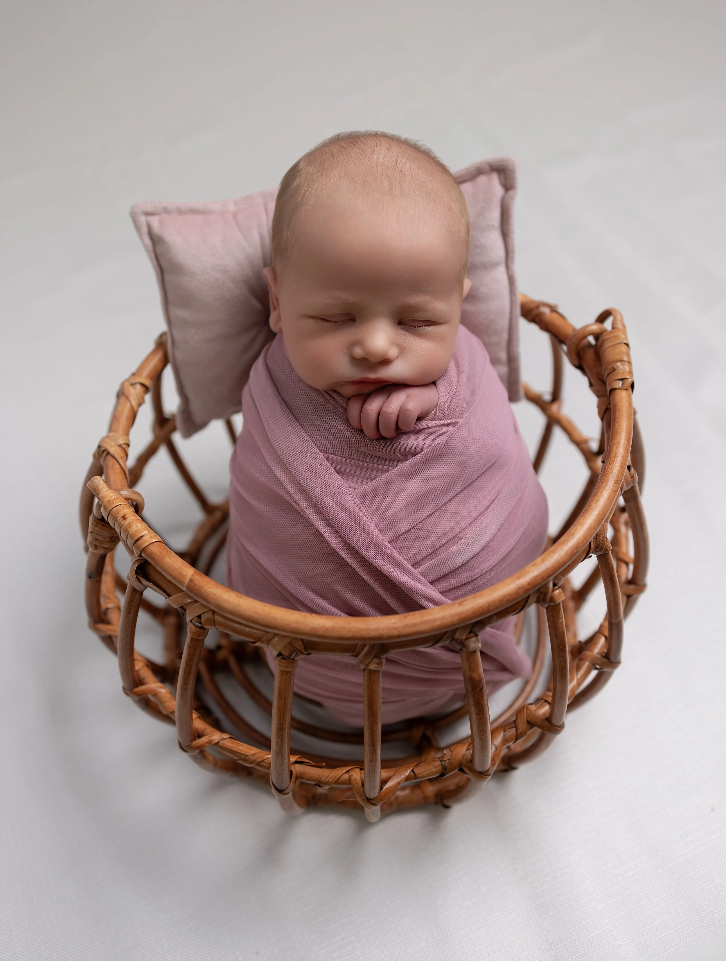 newborn baby in a basket