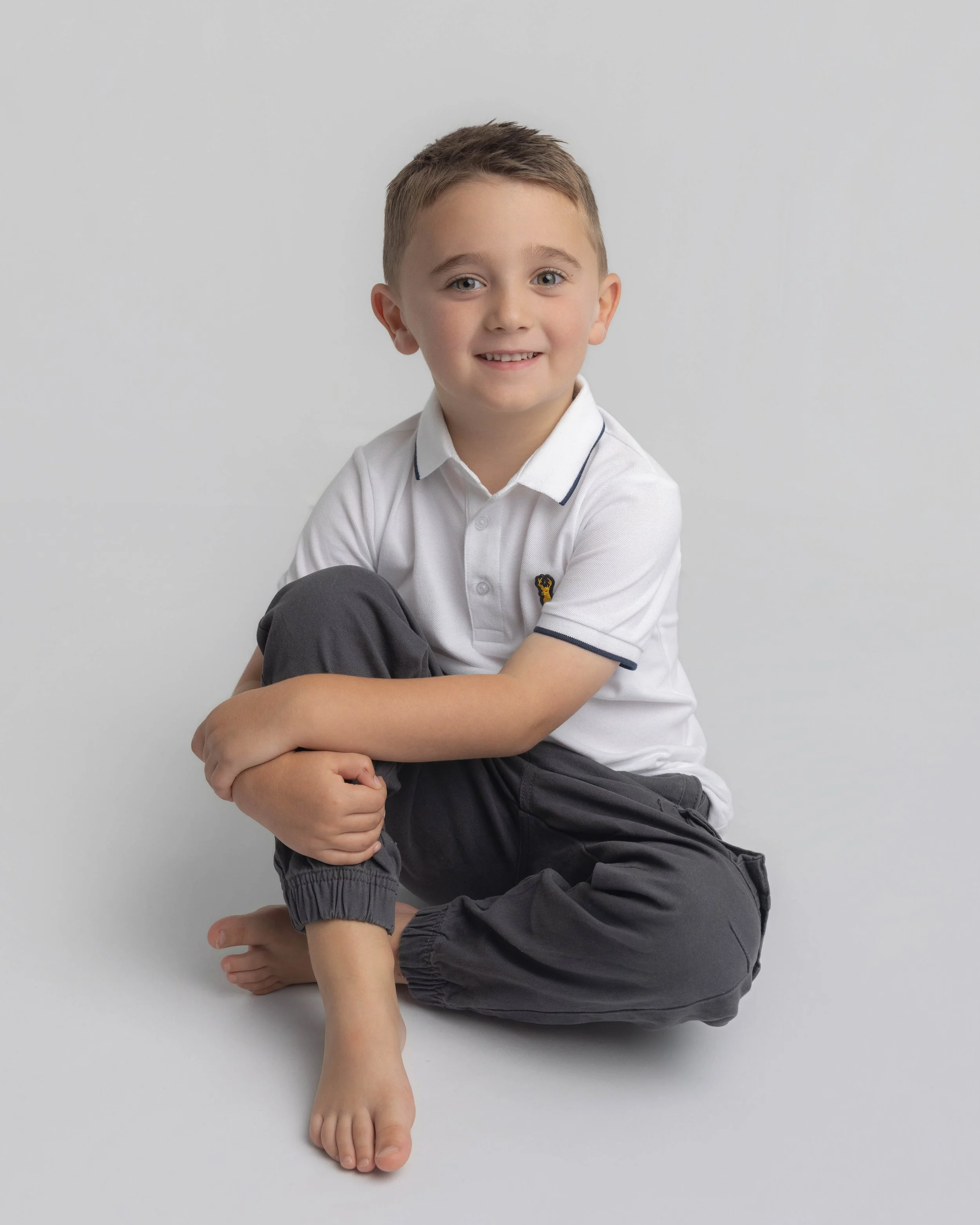 boy sat on floor on a photoshoot