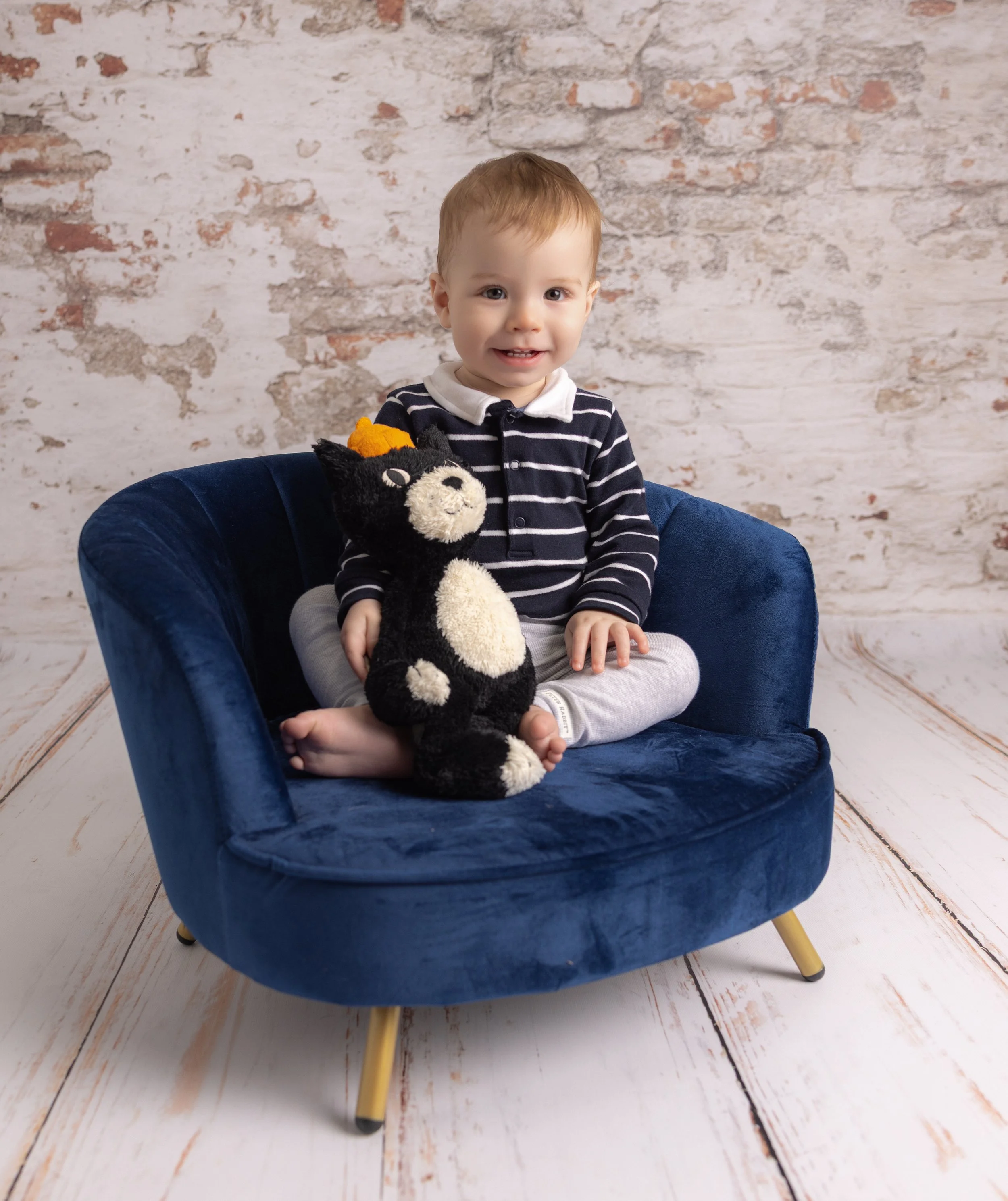Boy sat on a chair during a photoshoot