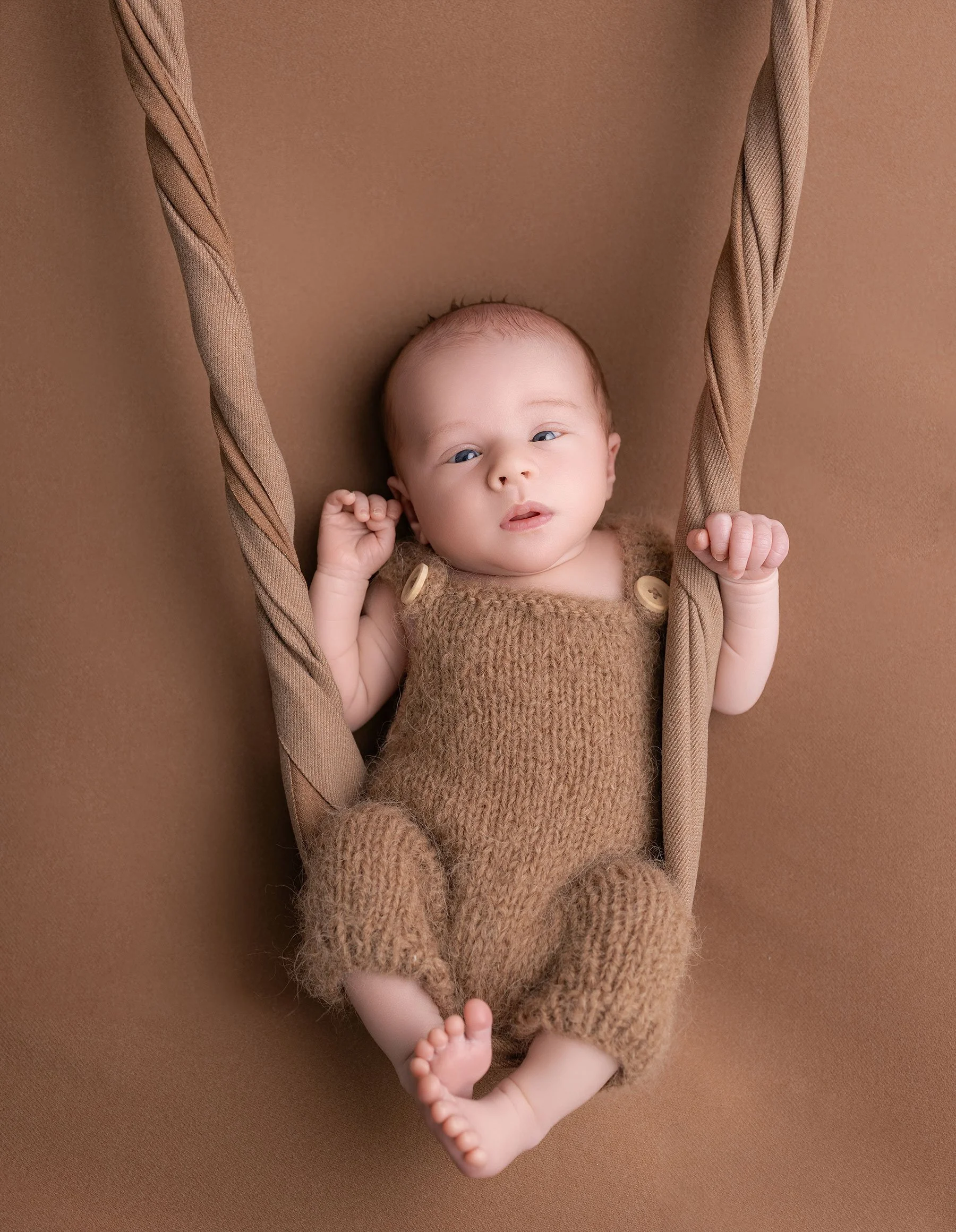 baby on a swing at photoshoot 