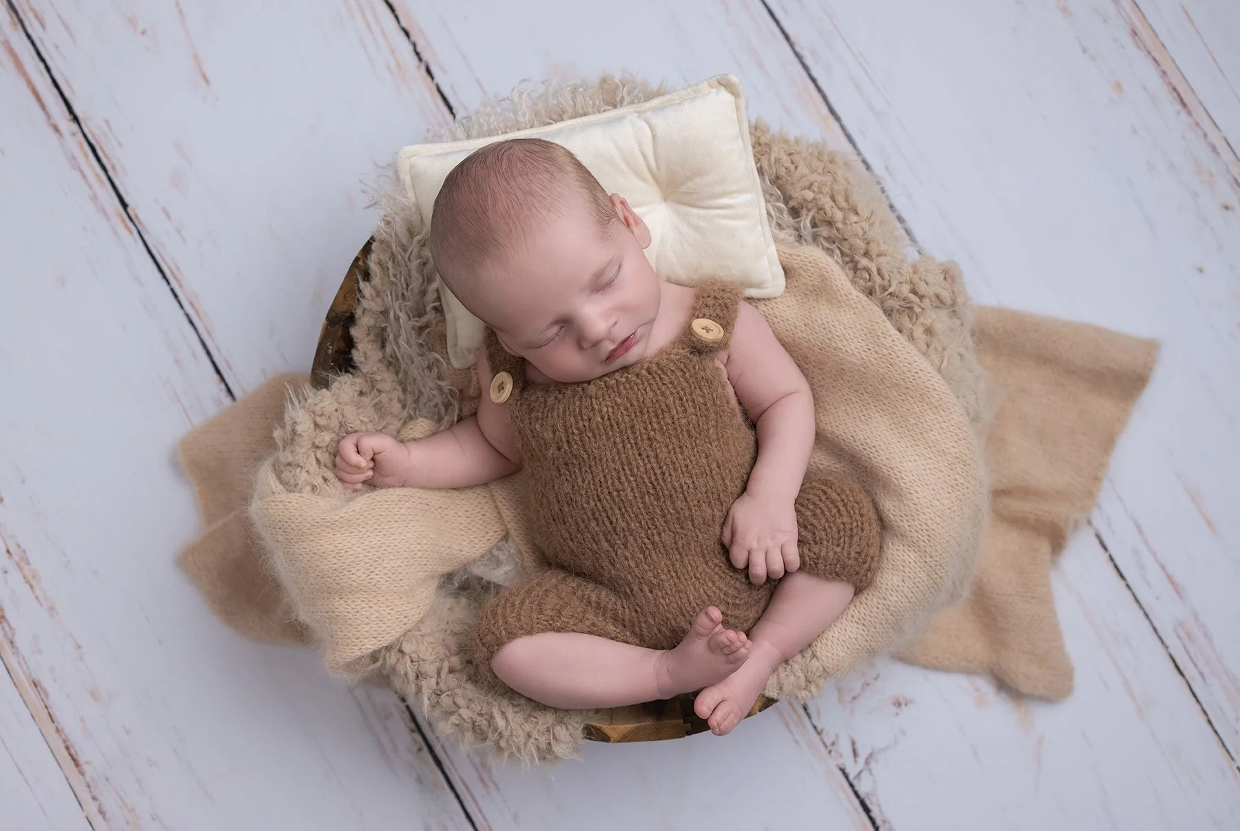 Baby dressed in beige on a photoshoot
