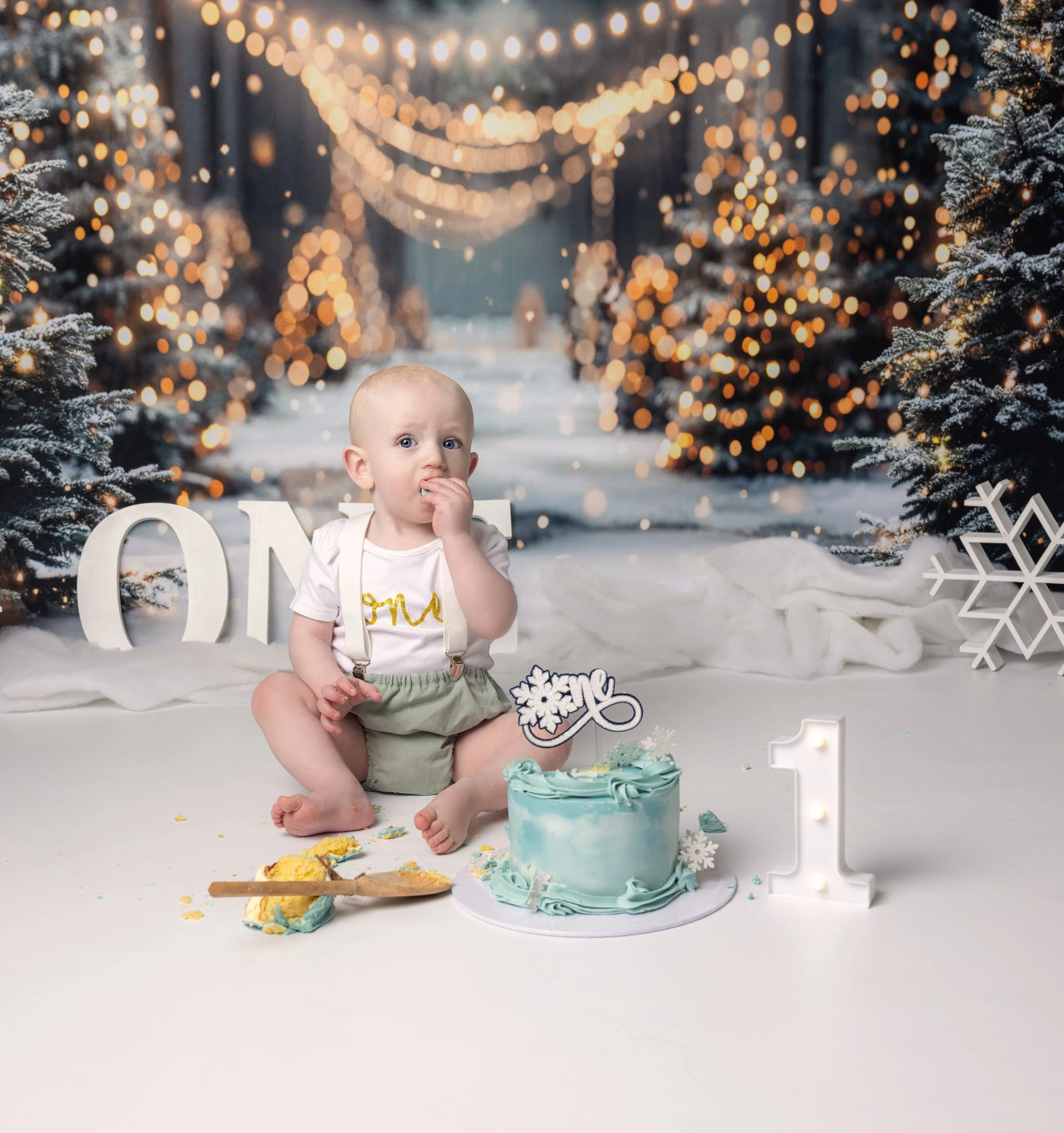 baby on Christmas themed cake smash