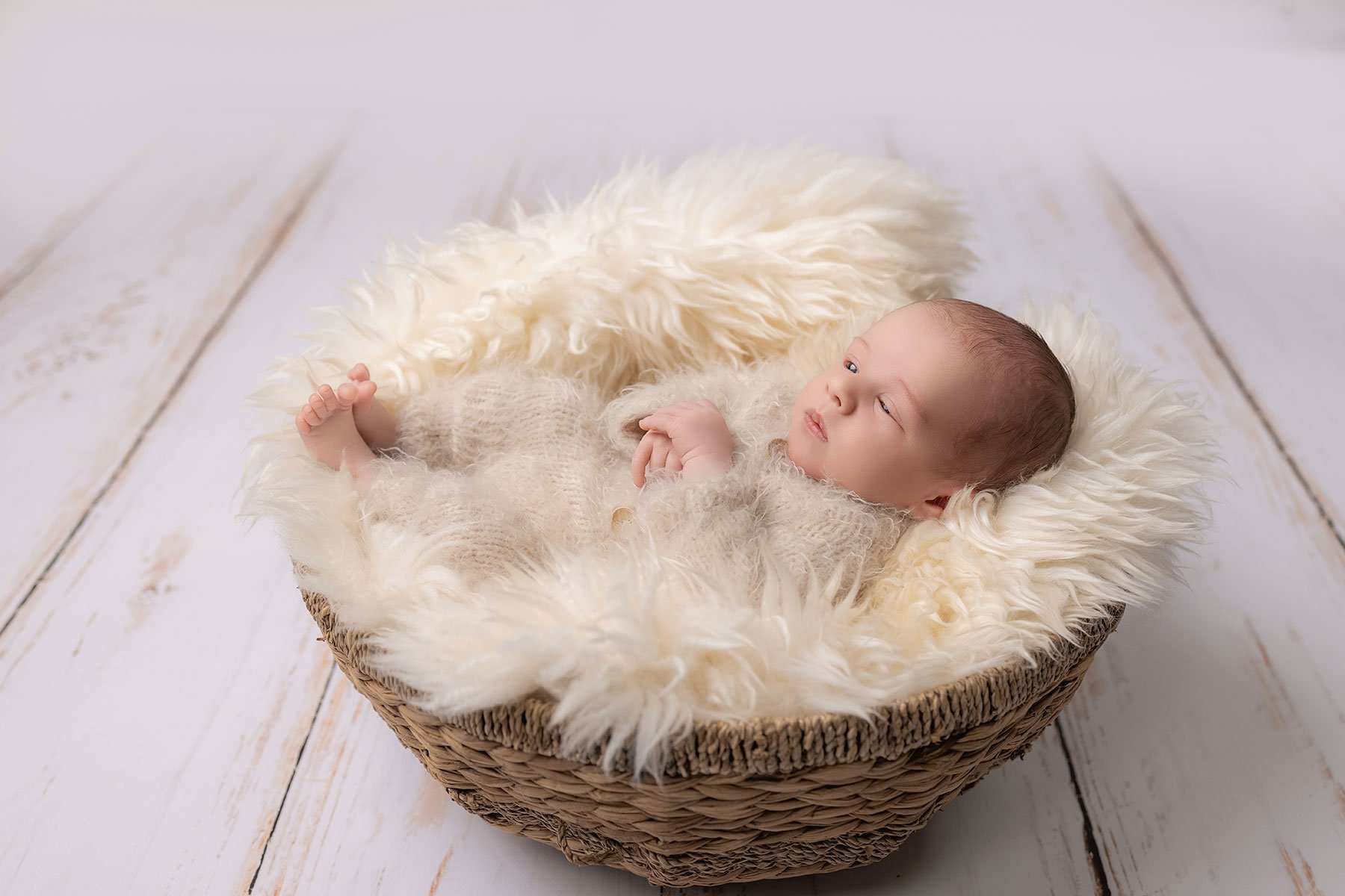 baby asleep in a basket