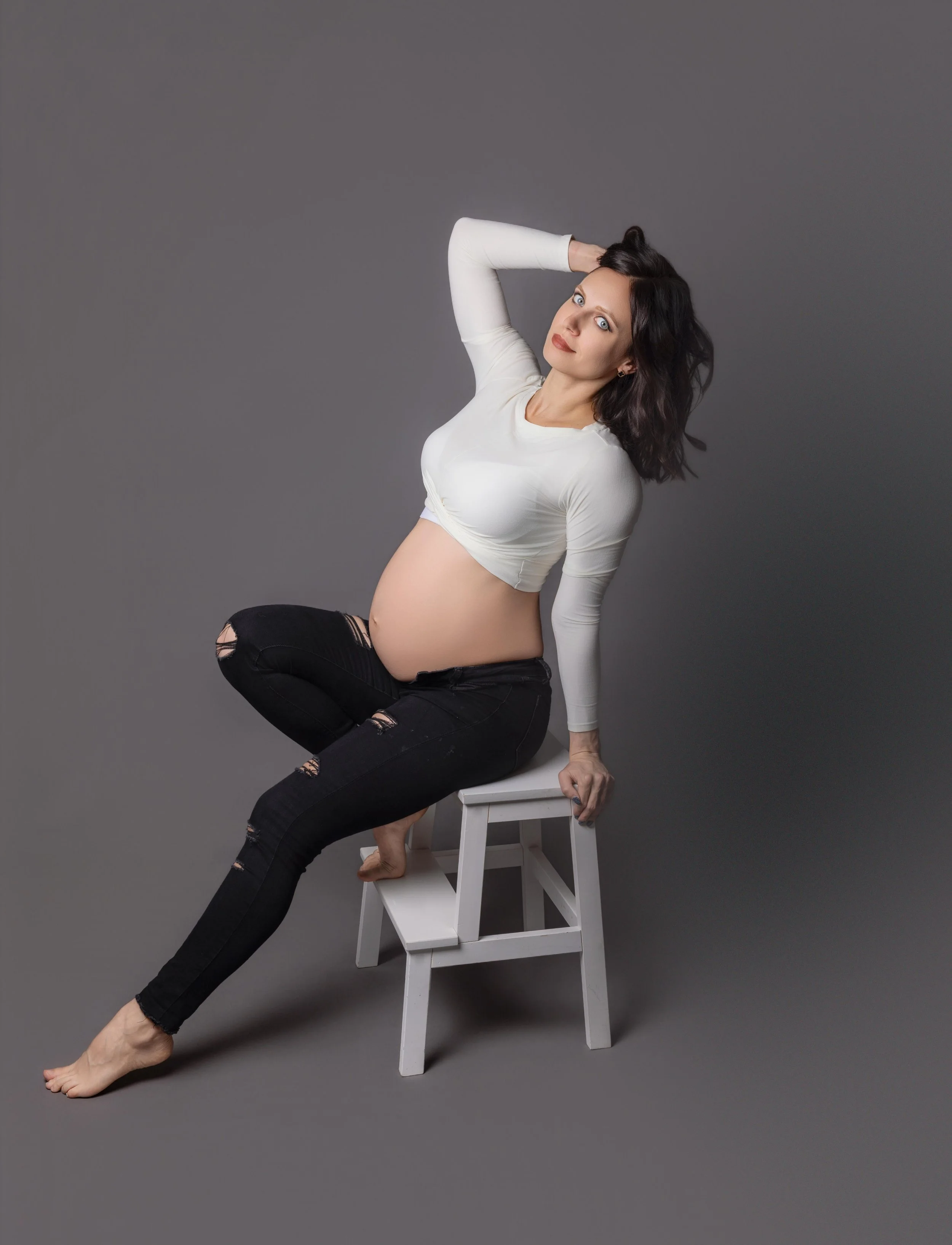 lady leaning back on a stool