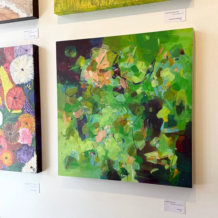 A lively green abstract painting installed on a gallery wall as part of a group show.