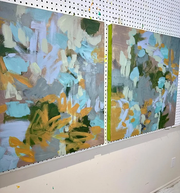 Two large square paintings in progress with soft colours in an abstract design.