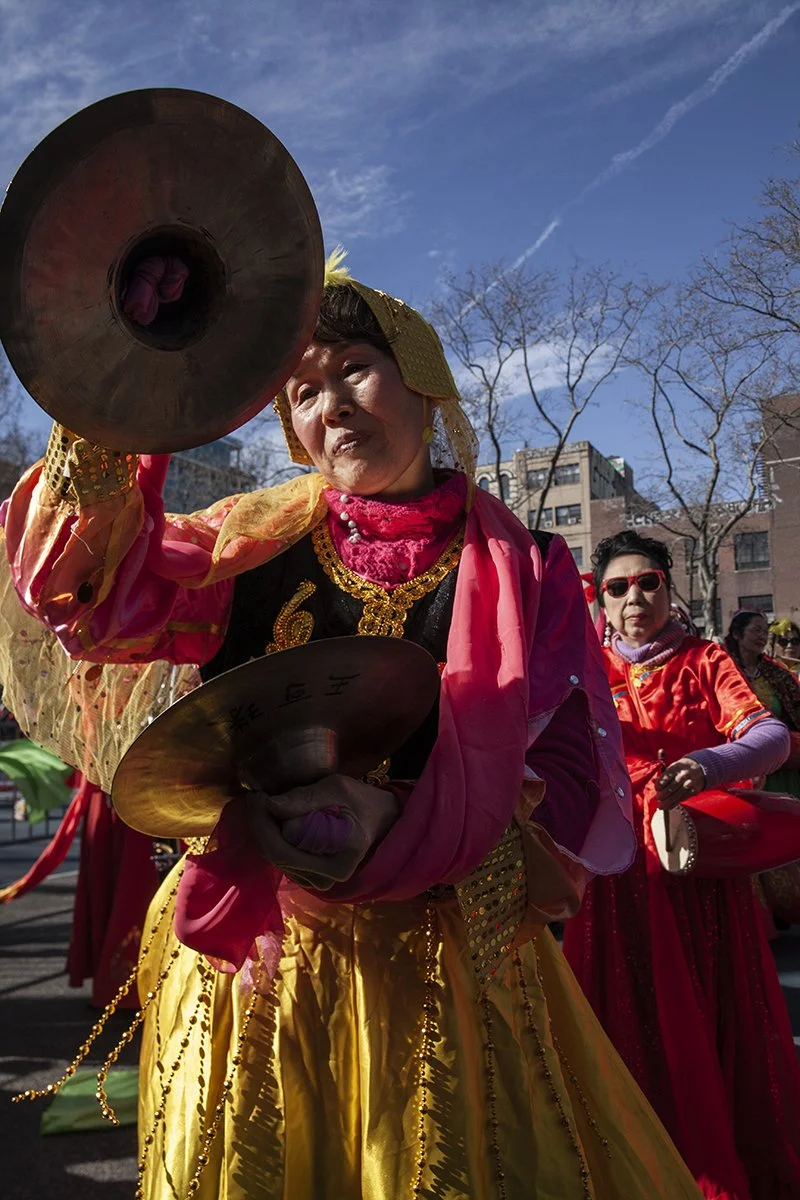 woman with cymbals firecracker festival.jpg
