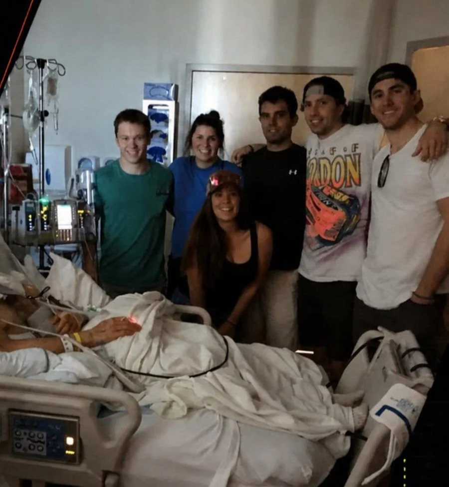 Friends at his hospital bedside after the 2017 skiing crash