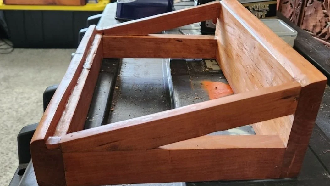 Pine laptop stand with a cherry finish.